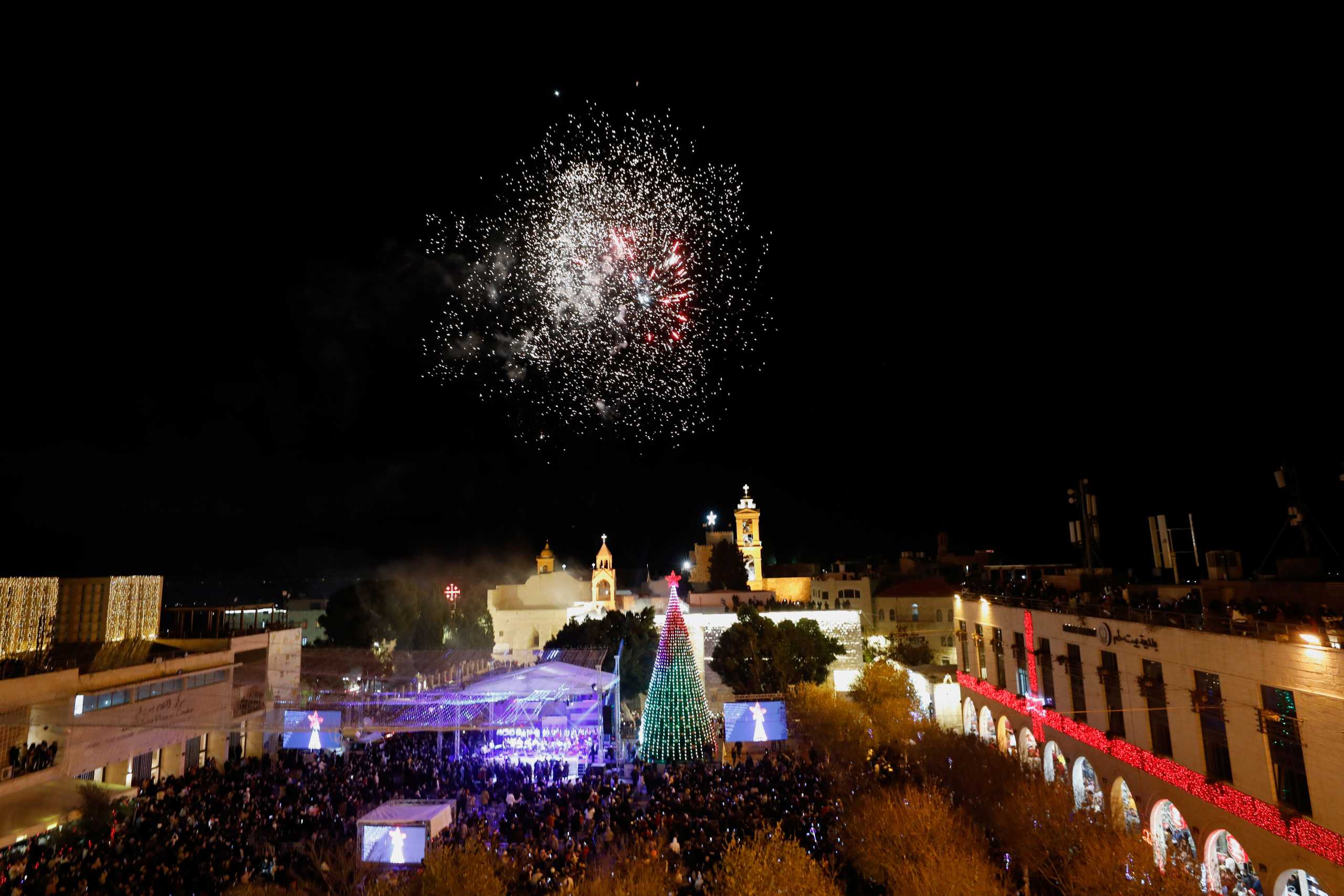 Palestinians light a Christmas tree at Manger Square outside the Church of the Nativity in Bethlehem, in the Israeli-occupied West Bank, December 4, 2021. REUTERS