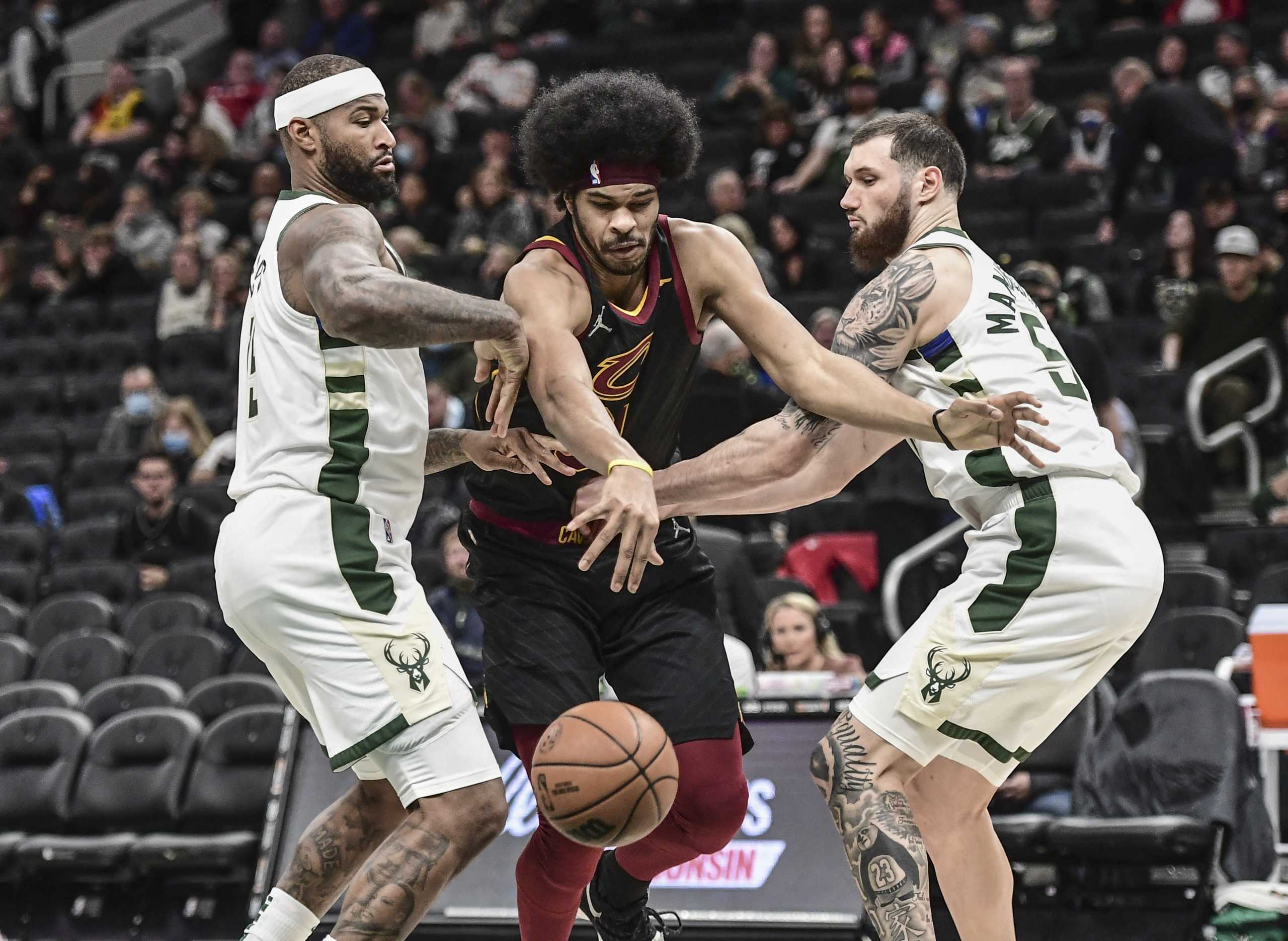 Dec 18, 2021; Milwaukee, Wisconsin, USA;  Cleveland Cavaliers center Jarrett Allen (31) reaches for the ball against Milwaukee Bucks center DeMarcus Cousins (15) and forward Sandro Mamukelashvili (54) in the fourth quarter at Fiserv Forum. Mandatory Credit: Benny Sieu-USA TODAY Sports
