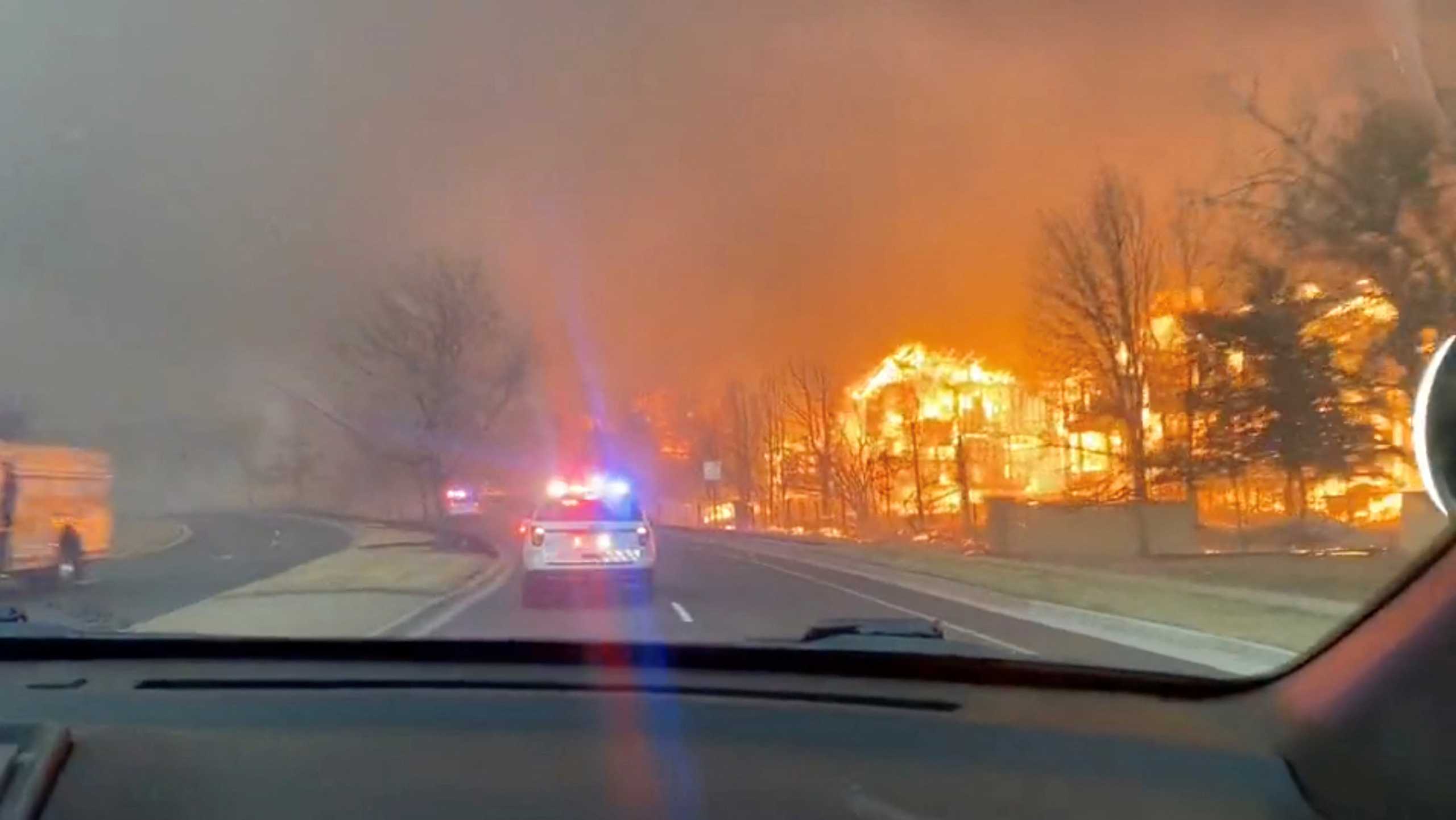 Footage of fires burning is seen from a Broomfield Police Department patrol car in Superior, Colorado, U.S., December 30, 2021, in this screen grab taken from a video. Video taken December 30, 2021. Broomfield Police Department