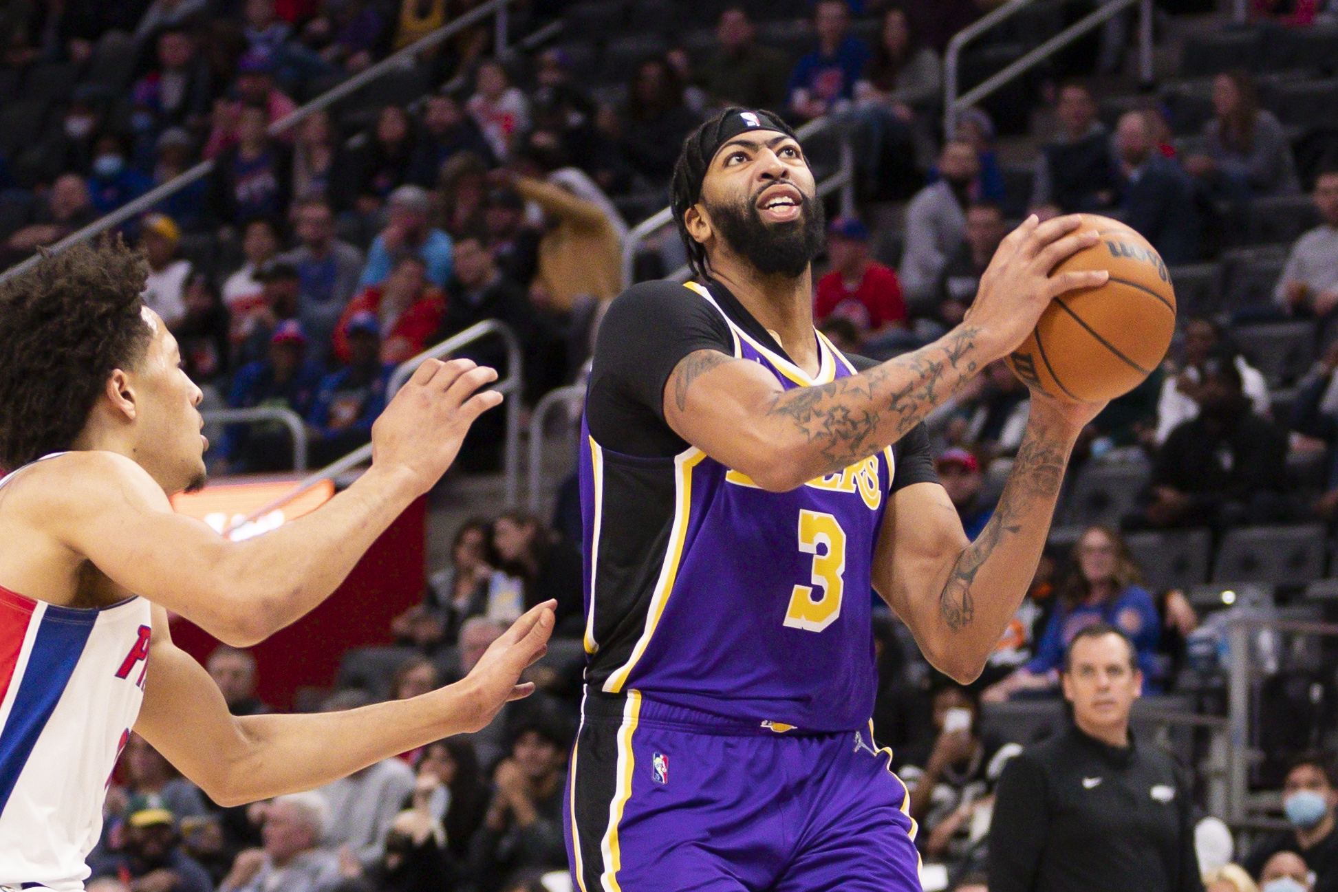 Nov 21, 2021; Detroit, Michigan, USA; Los Angeles Lakers forward Anthony Davis (3) goes up for a dunk against Detroit Pistons guard Cade Cunningham (2) during the first quarter at Little Caesars Arena. Mandatory Credit: Raj Mehta-USA TODAY Sports