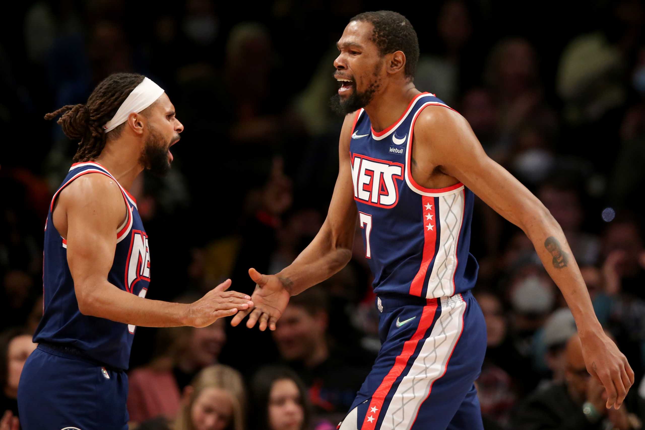 Dec 3, 2021; Brooklyn, New York, USA; Brooklyn Nets forward Kevin Durant (7) celebrates with guard Patty Mills (8) during the second quarter against the Minnesota Timberwolves at Barclays Center. Mandatory Credit: Brad Penner-USA TODAY Sports