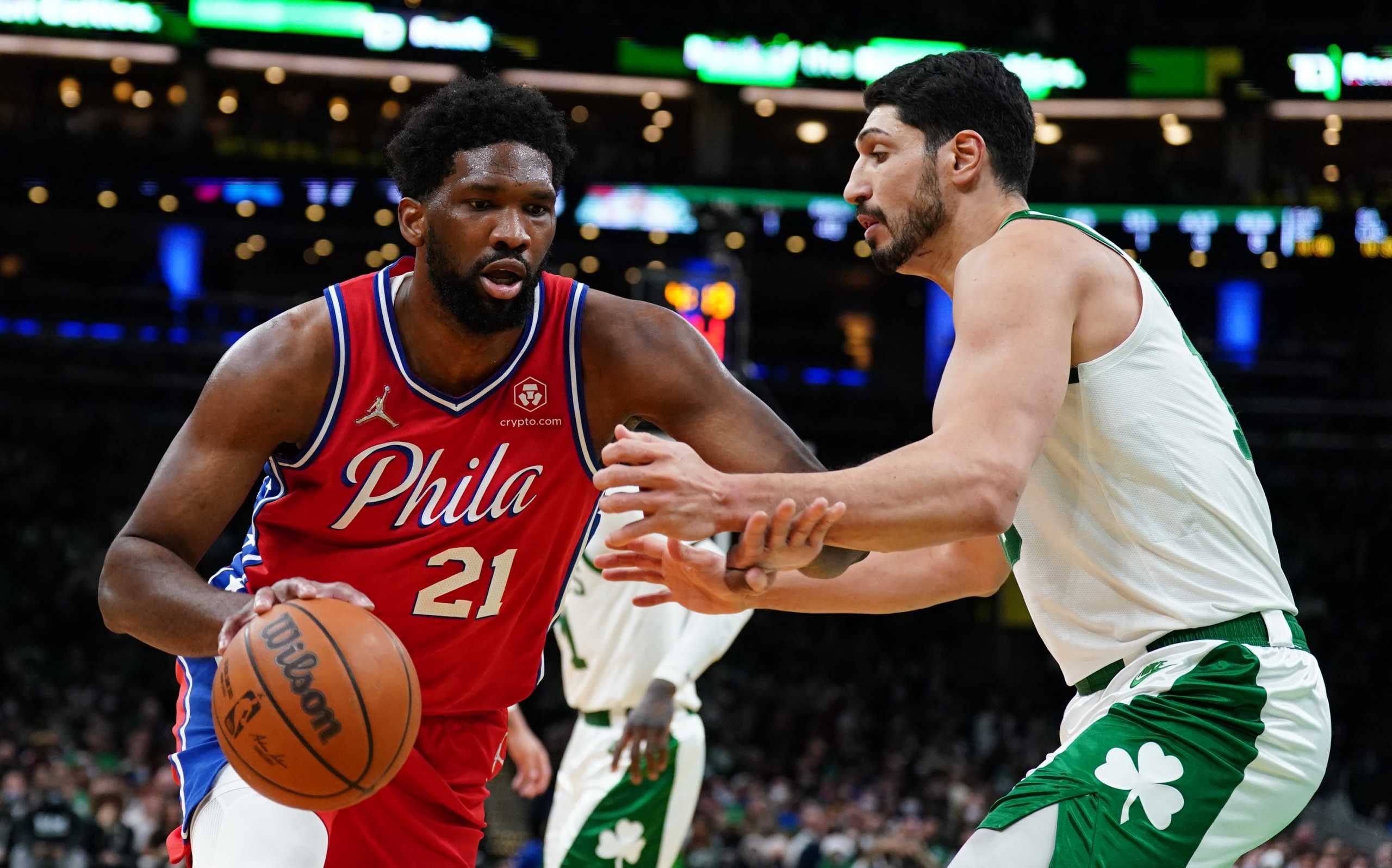 Dec 20, 2021; Boston, Massachusetts, USA; Philadelphia 76ers center Joel Embiid (21) drives the ball against Boston Celtics center Enes Freedom (13) in the first quarter at TD Garden. Mandatory Credit: David Butler II-USA TODAY Sports