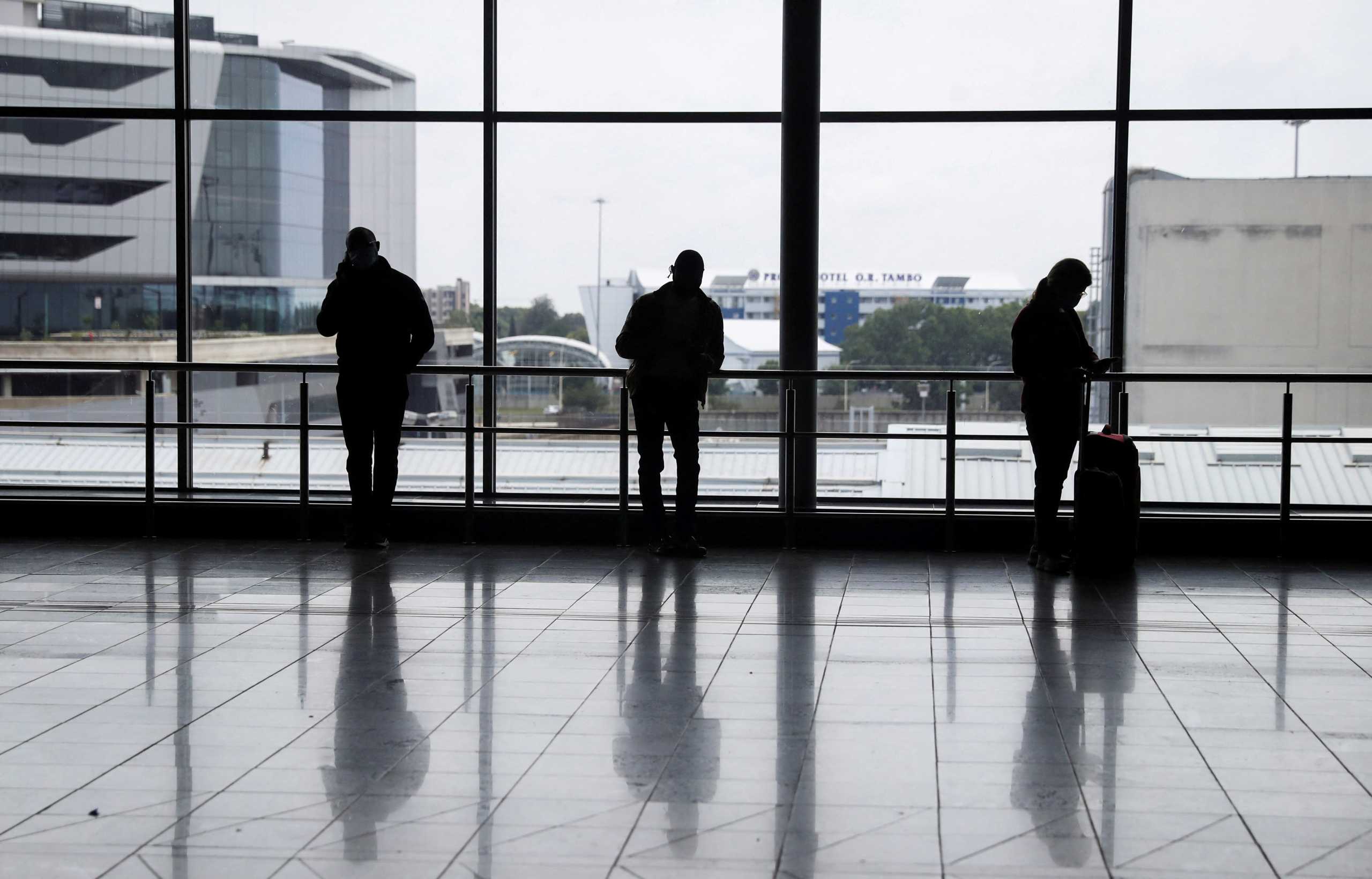 FILE PHOTO: Passengers wait to board international flights, amidst the spread of the new SARS-CoV-2 variant Omicron, at O.R. Tambo International Airport in Johannesburg, South Africa, November 28, 2021. REUTERS