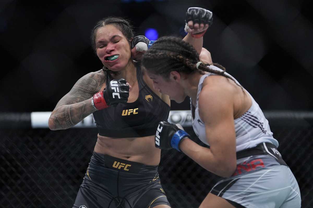 Dec 11, 2021; Las Vegas, Nevada, USA; Julianna Pena moves in with a hit against Amanda Nunes during UFC 269 at T-Mobile Arena. Mandatory Credit: Stephen R. Sylvanie-USA TODAY Sports
