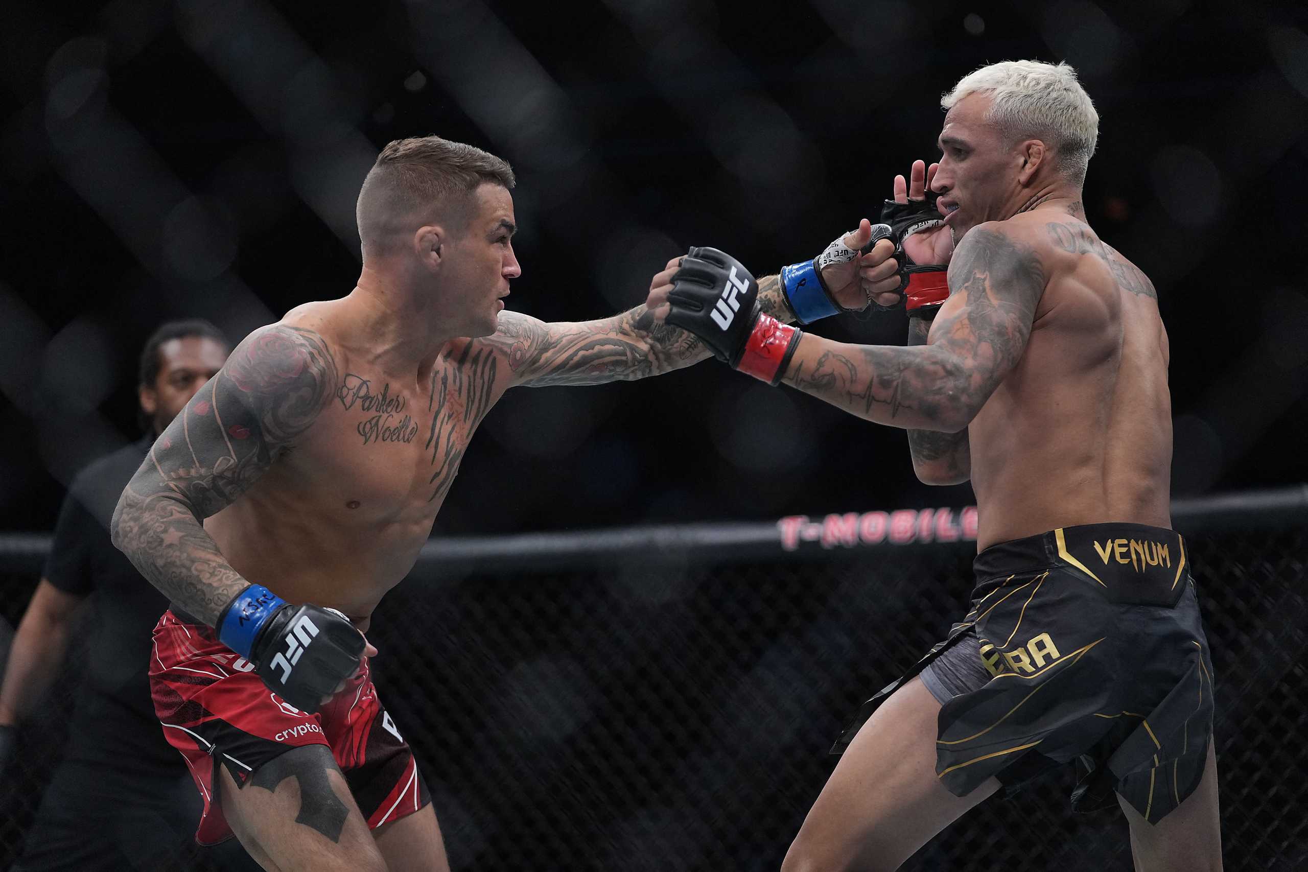 Dec 11, 2021; Las Vegas, Nevada, USA; Dustin Poirier moves in with a hit against Charles Oliveira during UFC 269 at T-Mobile Arena. Mandatory Credit: Stephen R. Sylvanie-USA TODAY Sports