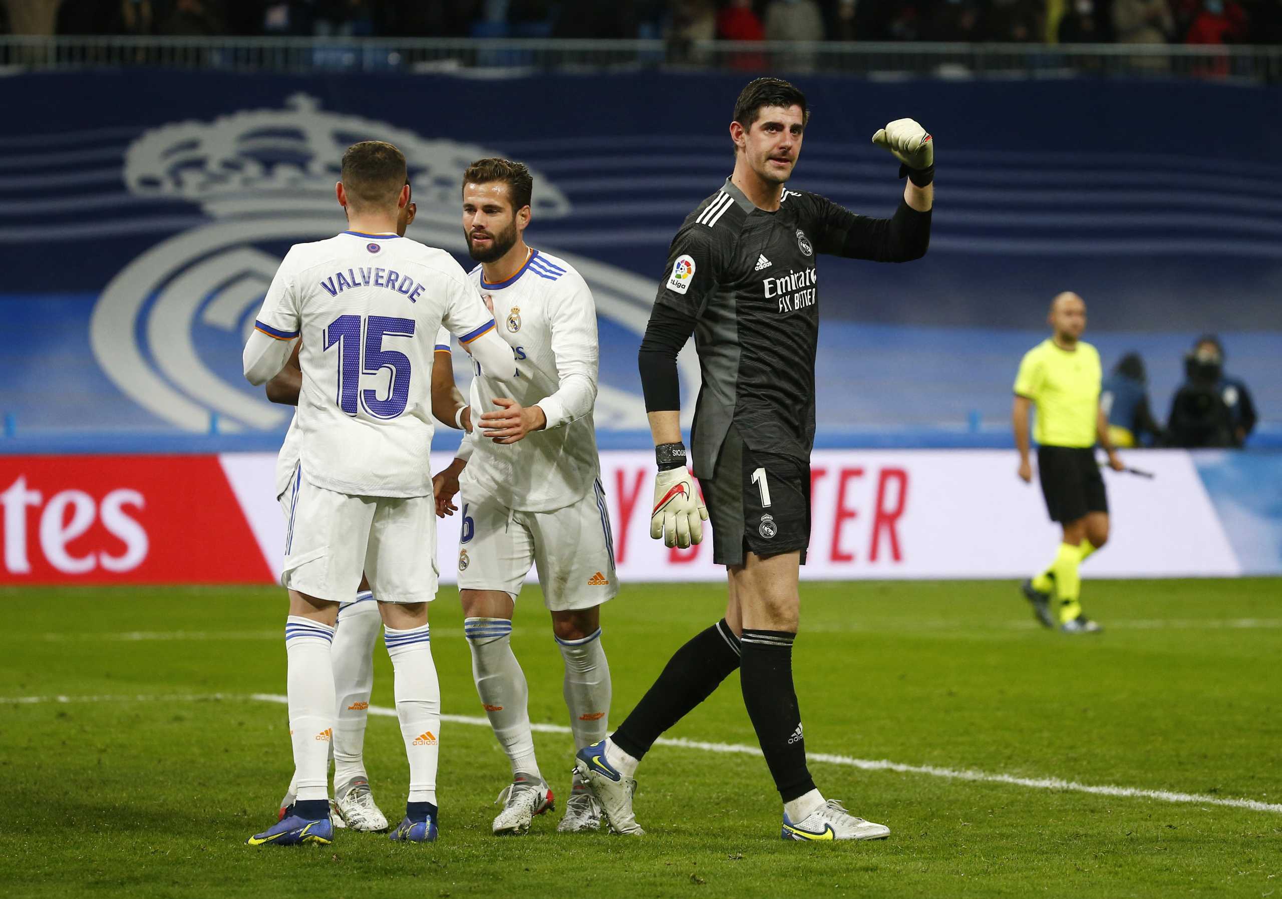 Soccer Football - LaLiga - Real Madrid v Atletico Madrid - Santiago Bernabeu, Madrid, Spain - December 12, 2021 Real Madrid's Thibaut Courtois, Nacho and Federico Valverde celebrate after the match REUTERS