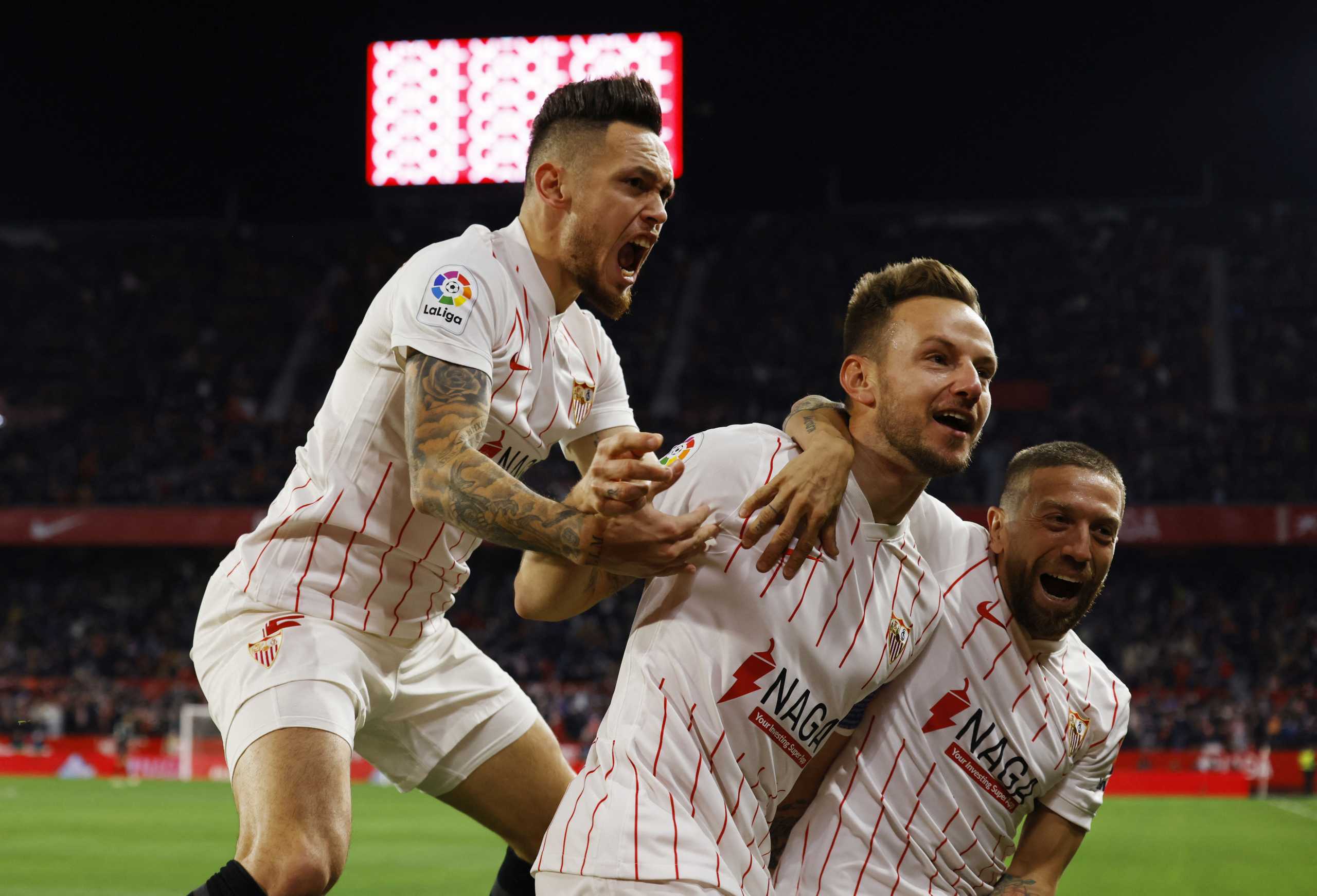 Soccer Football - LaLiga - Sevilla v Atletico Madrid - Ramon Sanchez Pizjuan, Seville, Spain - December 18, 2021 Sevilla's Ivan Rakitic celebrates scoring their first goal with teammates REUTERS