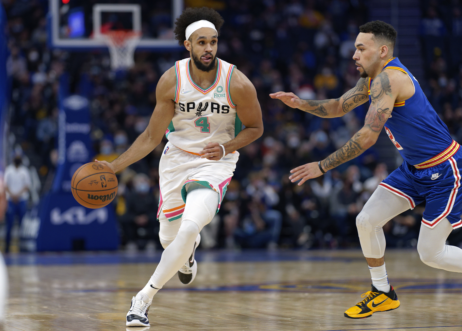 Dec 4, 2021; San Francisco, California, USA;  San Antonio Spurs guard Derrick White (4) drives the ball against Golden State Warriors guard Chris Chiozza (2) during the second quarter at Chase Center. Mandatory Credit: Stan Szeto-USA TODAY Sports