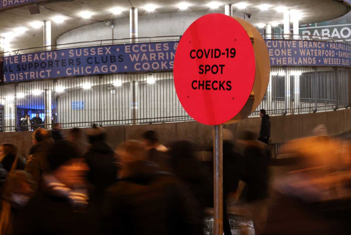 Soccer Football - Premier League - Manchester City v Leeds United - Etihad Stadium, Manchester, Britain - December 14, 2021 General view of a sign notifying fans of a coronavirus (COVID-19) check area outside the stadium before the match Action Images via Reuters