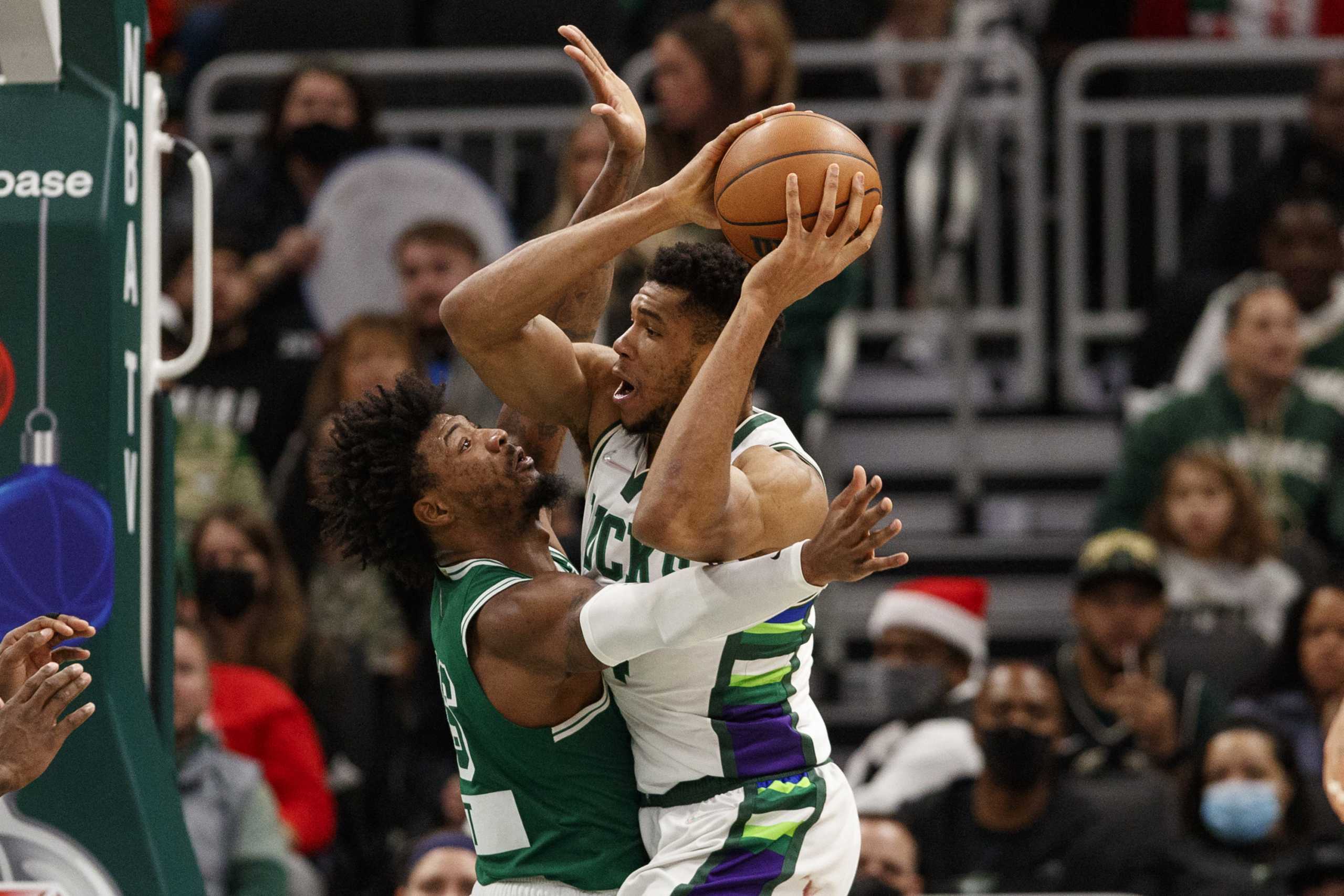 Dec 25, 2021; Milwaukee, Wisconsin, USA;  Boston Celtics guard Marcus Smart (36) defends Milwaukee Bucks forward Giannis Antetokounmpo (34) during the third quarter at Fiserv Forum. Mandatory Credit: Jeff Hanisch-USA TODAY Sports