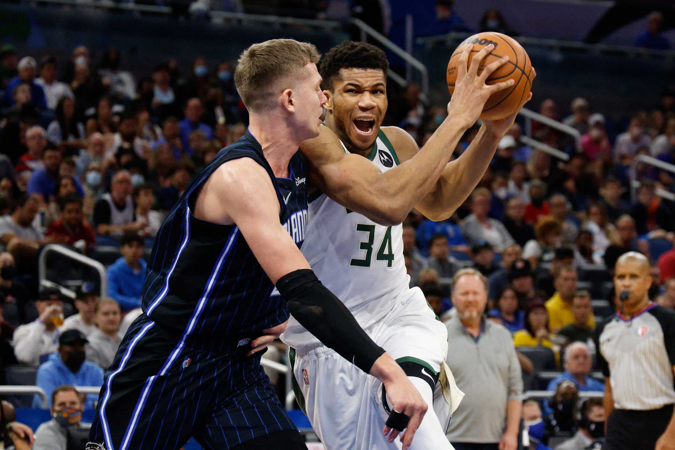 Dec 28, 2021; Orlando, Florida, USA;  Milwaukee Bucks forward Giannis Antetokounmpo (34) drives to the basket past Orlando Magic center Moritz Wagner (21) in the second half at Amway Center. Mandatory Credit: Nathan Ray Seebeck-USA TODAY Sports