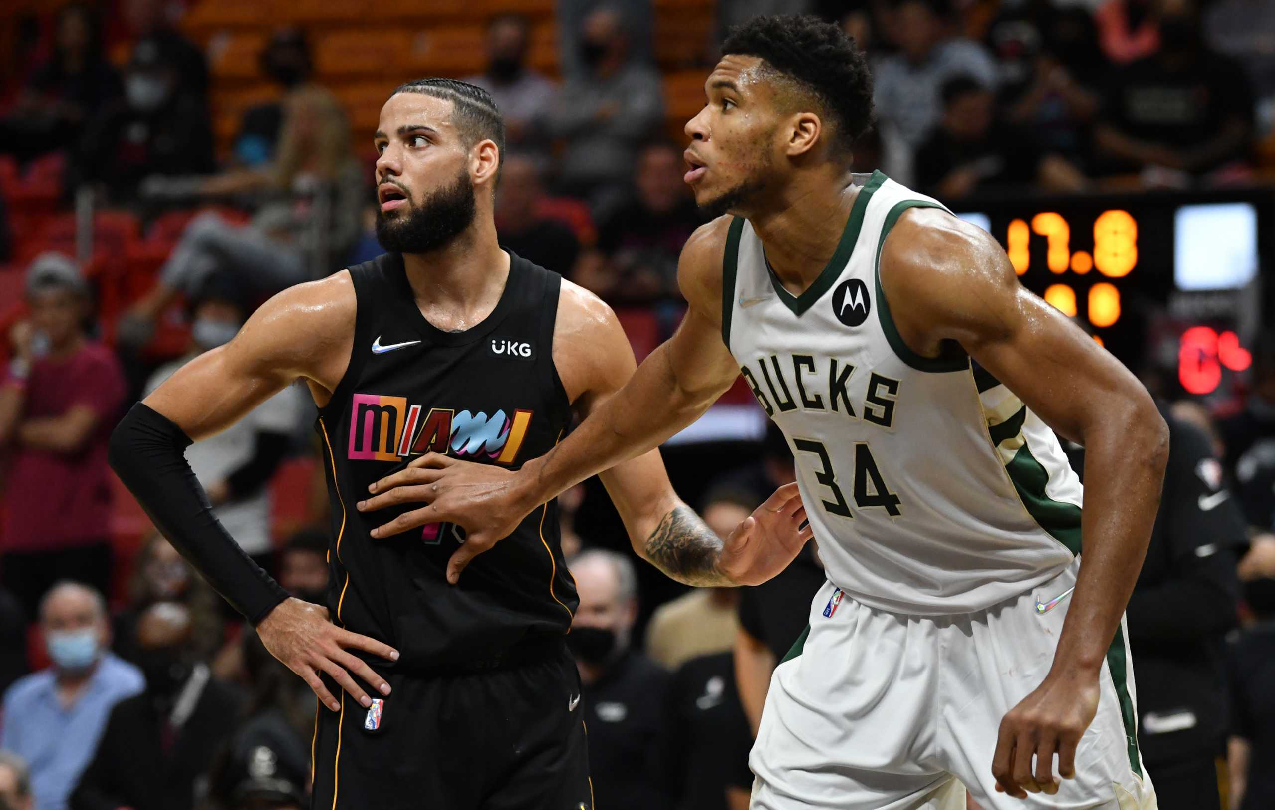 Dec 8, 2021; Miami, Florida, USA; Miami Heat forward Caleb Martin (16) and Milwaukee Bucks forward Giannis Antetokounmpo (34) wait for free throws to be taken in the second half at FTX Arena. Mandatory Credit: Jim Rassol-USA TODAY Sports