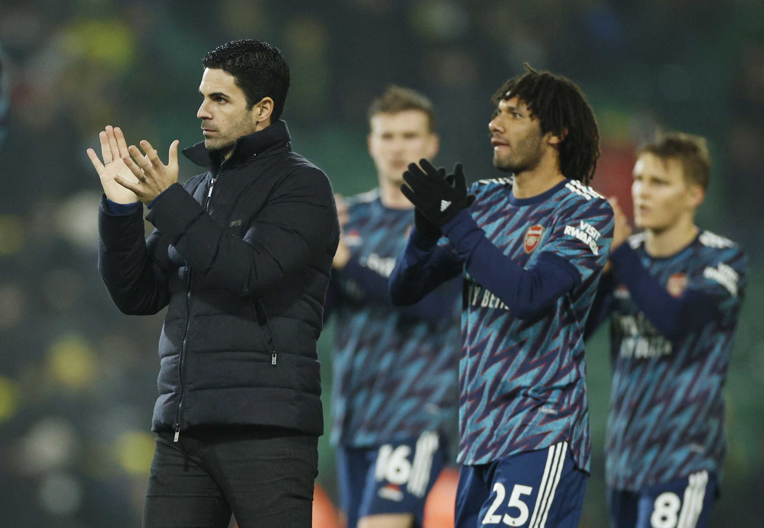 Soccer Football - Premier League - Norwich City v Arsenal - Carrow Road, Norwich, Britain - December 26, 2021 Arsenal manager Mikel Arteta and Mohamed Elneny applaud fans after the match Action Images via Reuters
