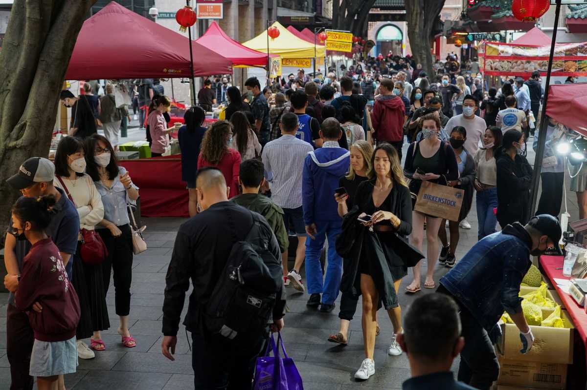 People walk through a street market in the city centre, as coronavirus disease (COVID-19) vaccination rates continue to rise, in Sydney, Australia, November 19, 2021.  REUTERS