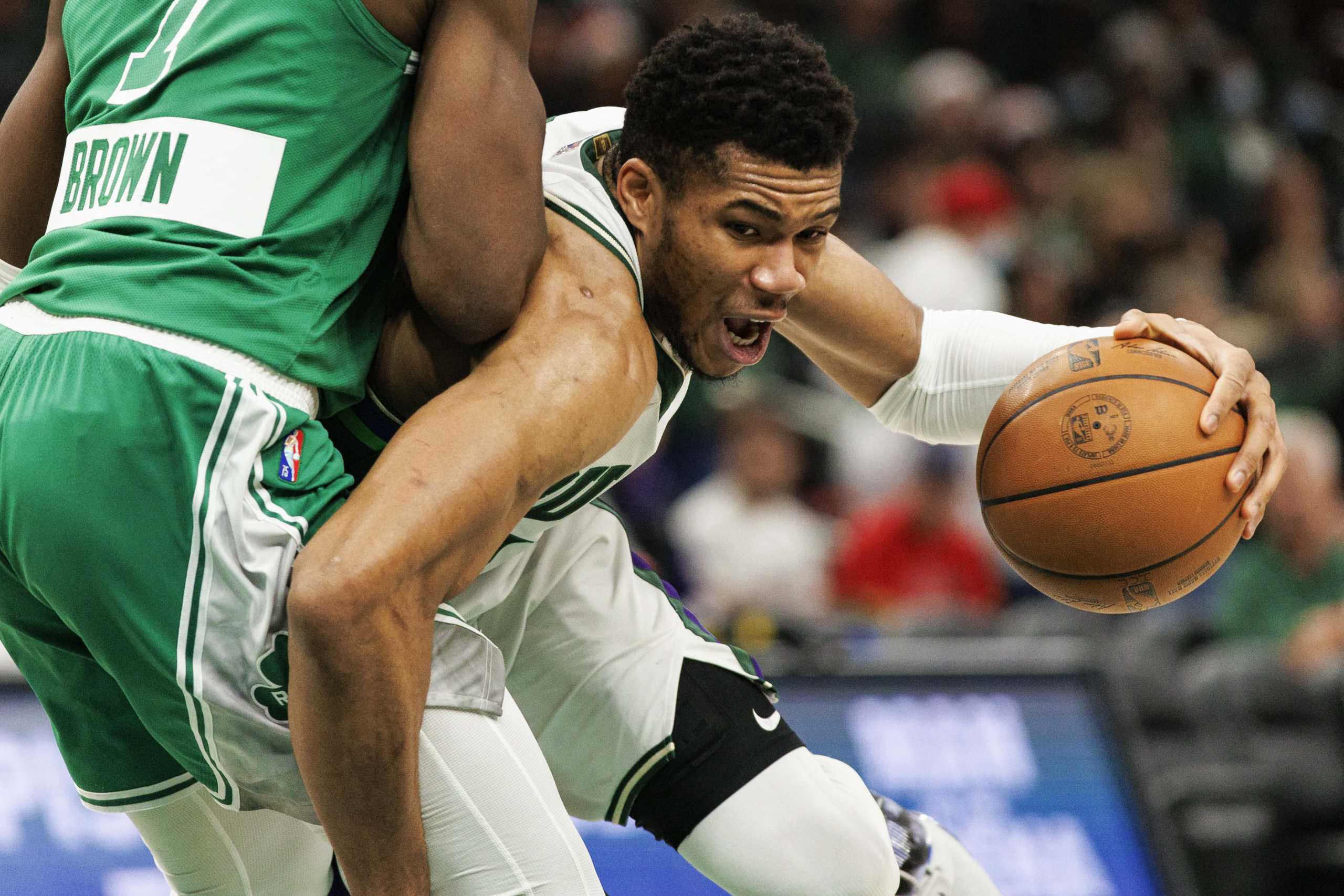 Dec 25, 2021; Milwaukee, Wisconsin, USA;  Milwaukee Bucks forward Giannis Antetokounmpo (34) drives for the basket around Boston Celtics guard Jaylen Brown (7) during the second quarter at Fiserv Forum. Mandatory Credit: Jeff Hanisch-USA TODAY Sports