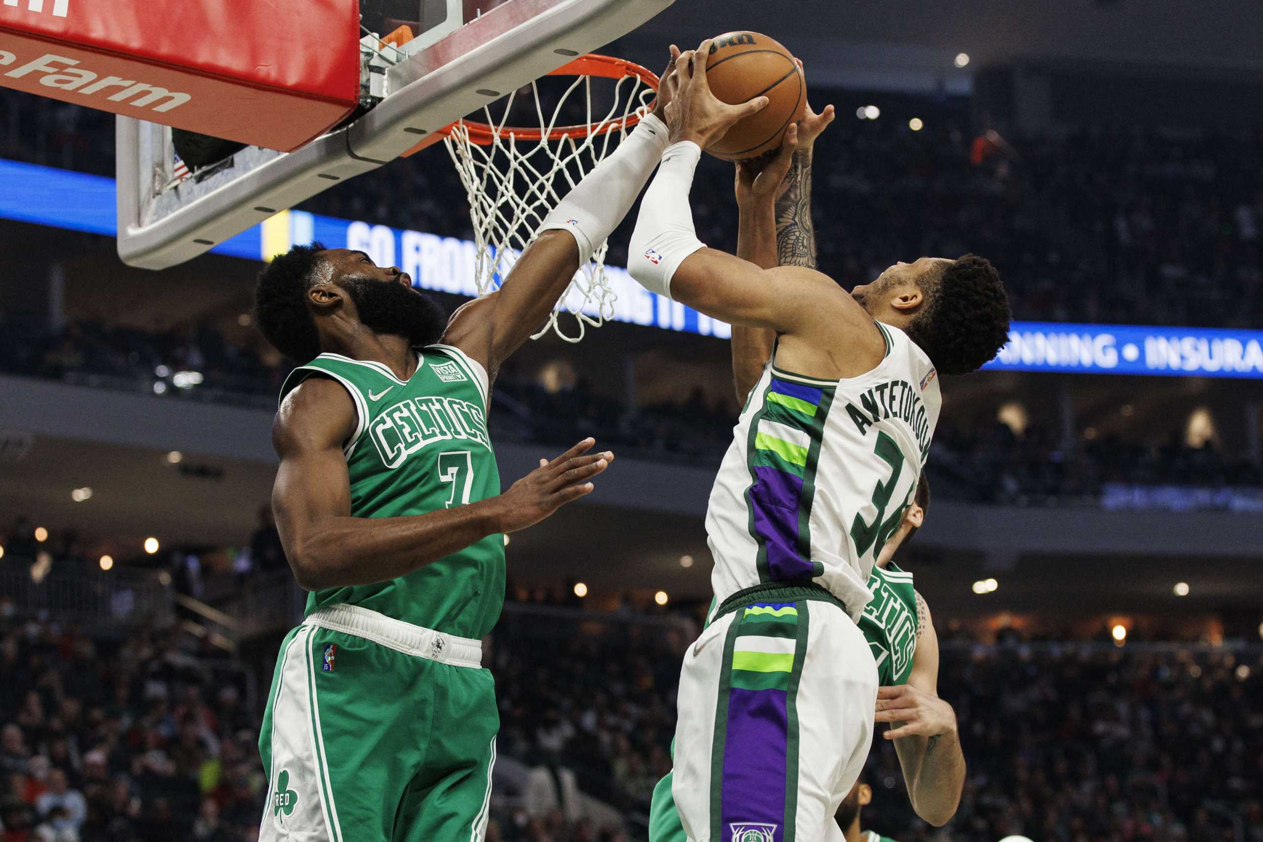 Dec 25, 2021; Milwaukee, Wisconsin, USA;  Boston Celtics guard Jaylen Brown (7) blocks the shot of Milwaukee Bucks forward Giannis Antetokounmpo (34) during the first quarter at Fiserv Forum. Mandatory Credit: Jeff Hanisch-USA TODAY Sports