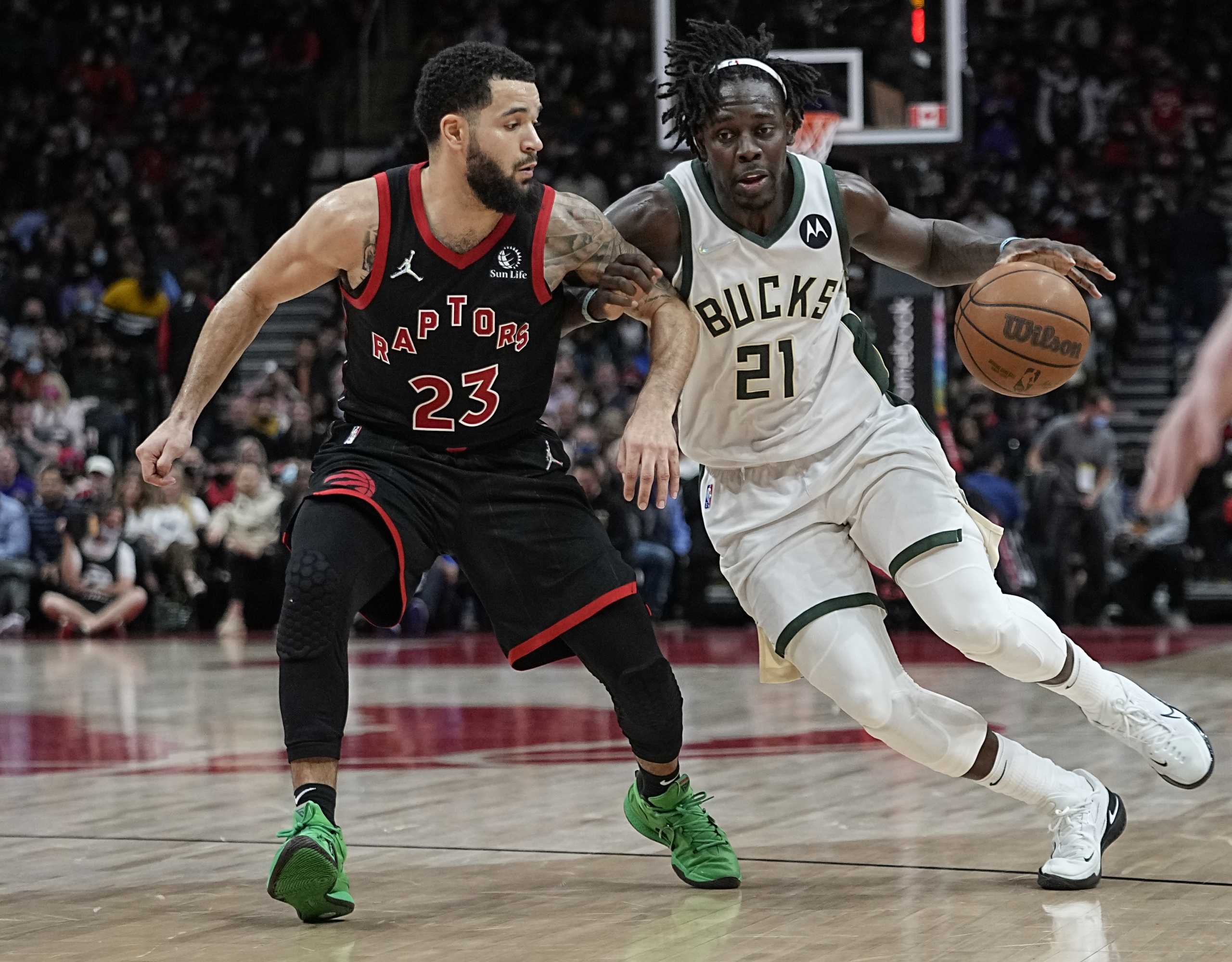 Dec 2, 2021; Toronto, Ontario, CAN; Milwaukee Bucks guard Jrue Holiday (21) drives to the net against Toronto Raptors guard Fred VanVleet (23) during the second half at Scotiabank Arena. Mandatory Credit: John E. Sokolowski-USA TODAY Sports