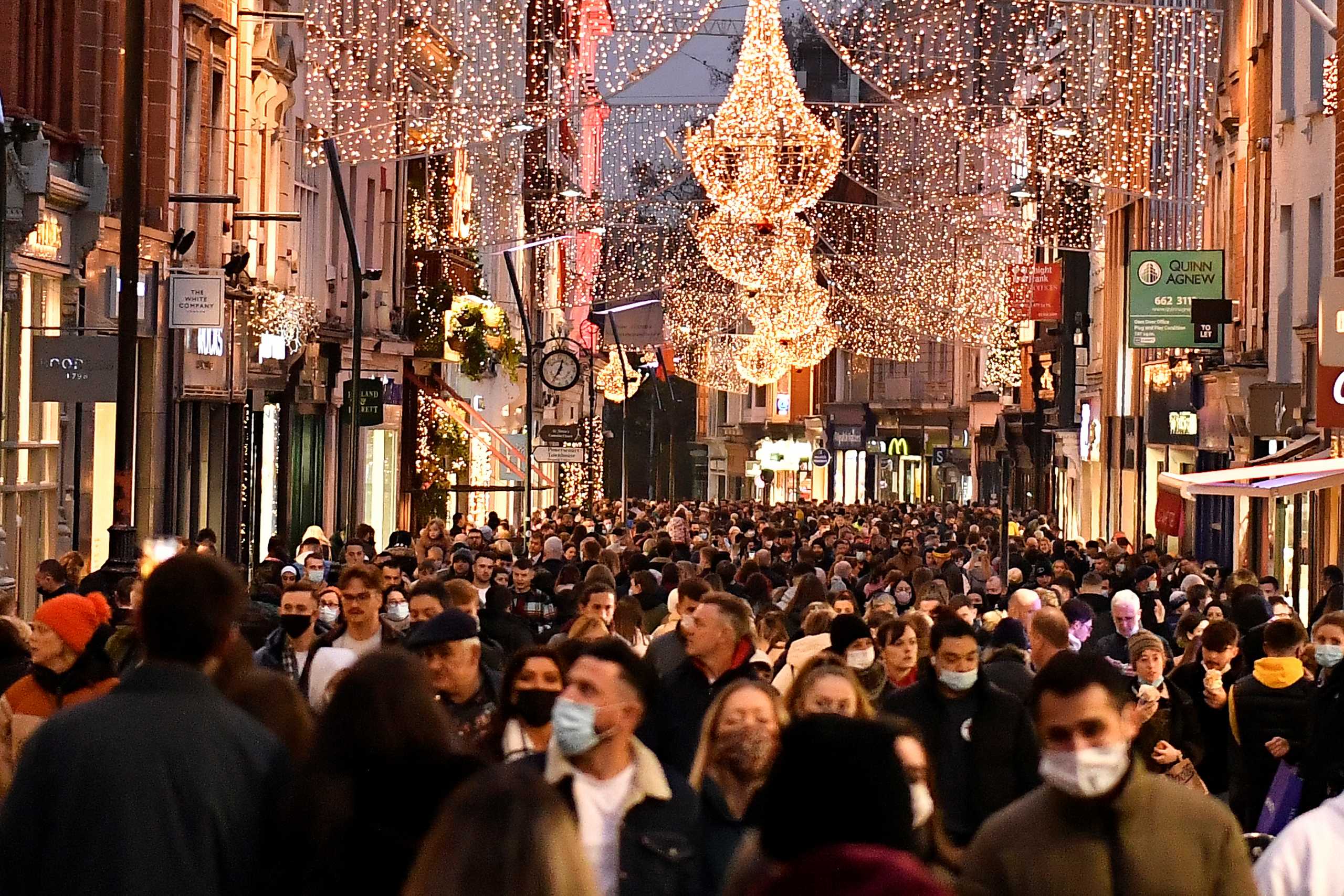 Christmas shoppers walk along Grafton Street in Dublin, Ireland, December 19, 2021. REUTERS