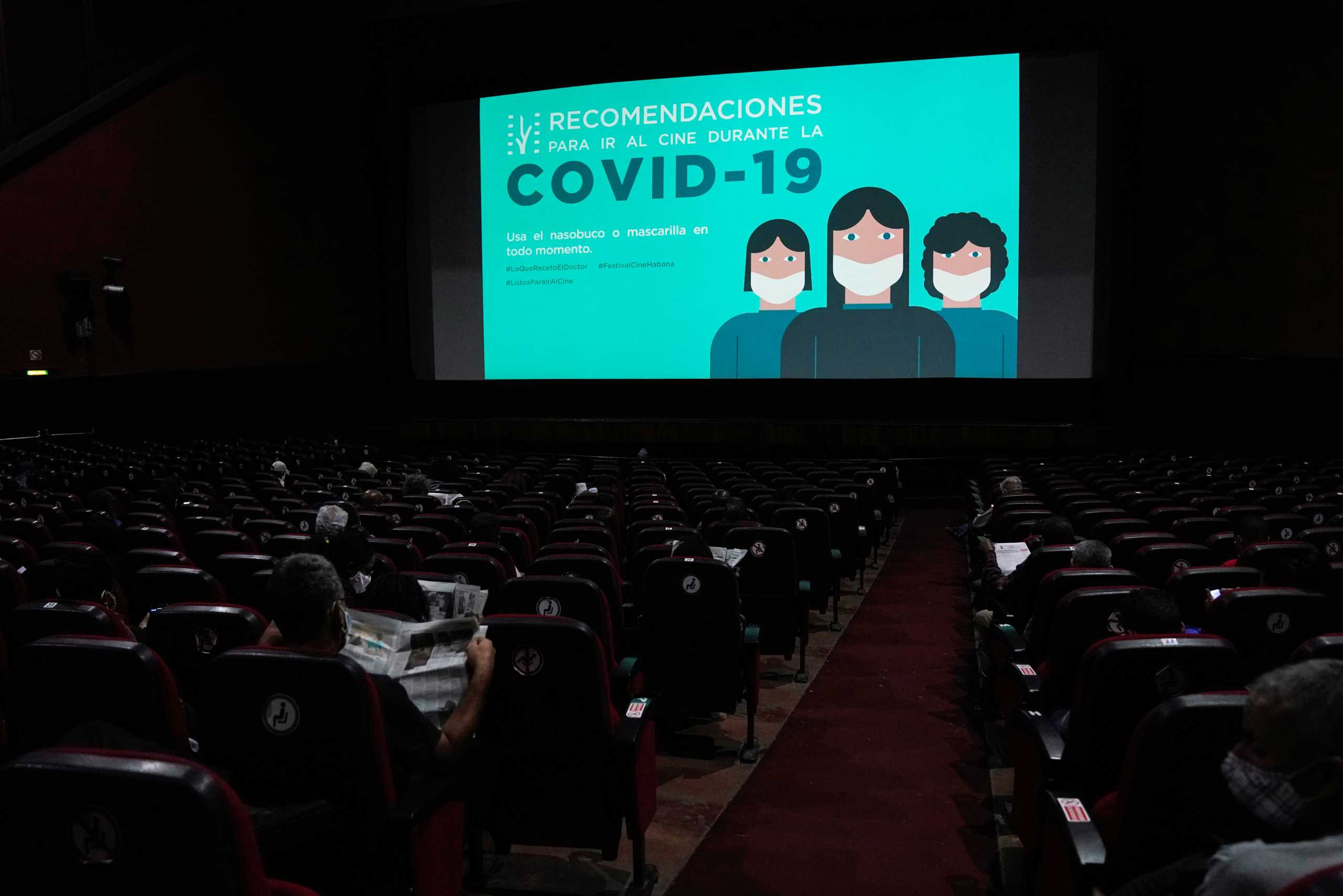 A coronavirus disease (COVID-19) health recommendation is seen on screen at the Yara cinema on the opening day of the International Festival of New Latin American Cinema, in Havana, Cuba December 3, 2021. REUTERS