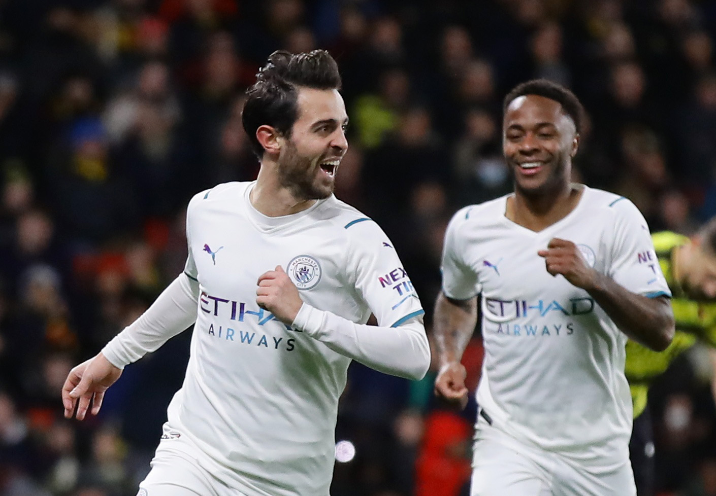Soccer Football - Premier League - Watford v Manchester City - Vicarage Road, Watford, Britain - December 4, 2021 Manchester City's Bernardo Silva celebrates scoring their third goal with Raheem Sterling REUTERS