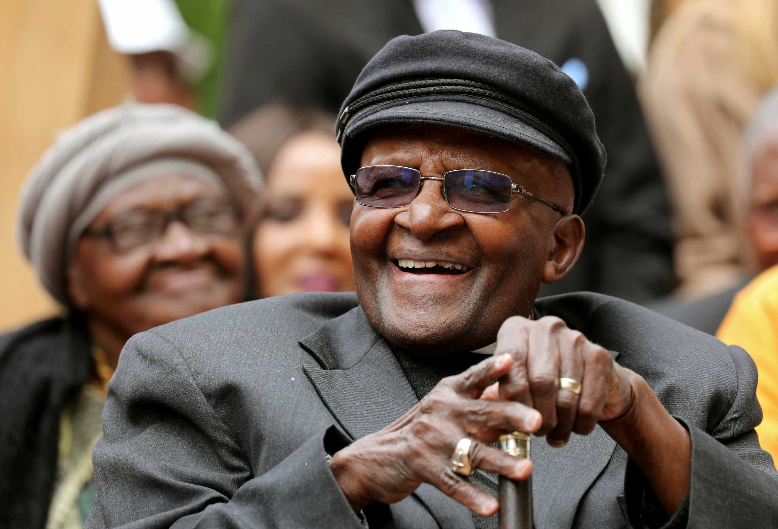 FILE PHOTO: Archbishop Desmond Tutu laughs as crowds gather to celebrate his birthday by unveiling an arch in his honour outside St George's Cathedral in Cape Town, South Africa, October 7, 2017. REUTERS