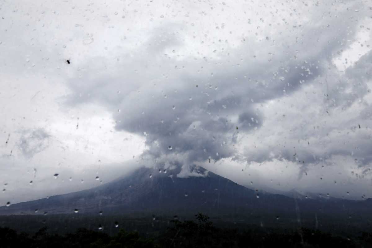 Mount Semeru volcano is seen through glass from the Volcano Observatory in Candipuro district following its eruption, Lumajang regency, Indonesia, December 6, 2021. REUTERS