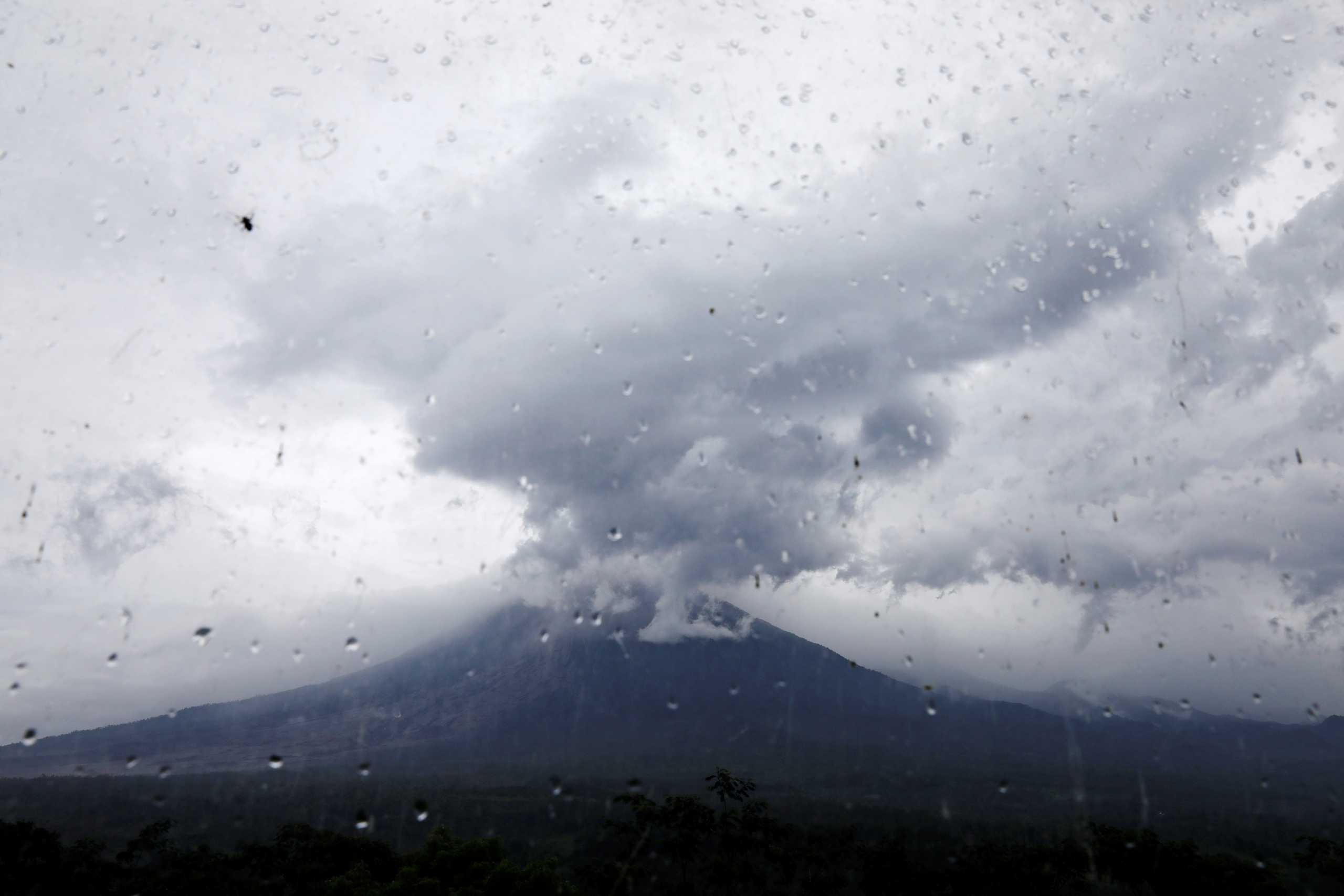 Mount Semeru volcano is seen through glass from the Volcano Observatory in Candipuro district following its eruption, Lumajang regency, Indonesia, December 6, 2021. REUTERS