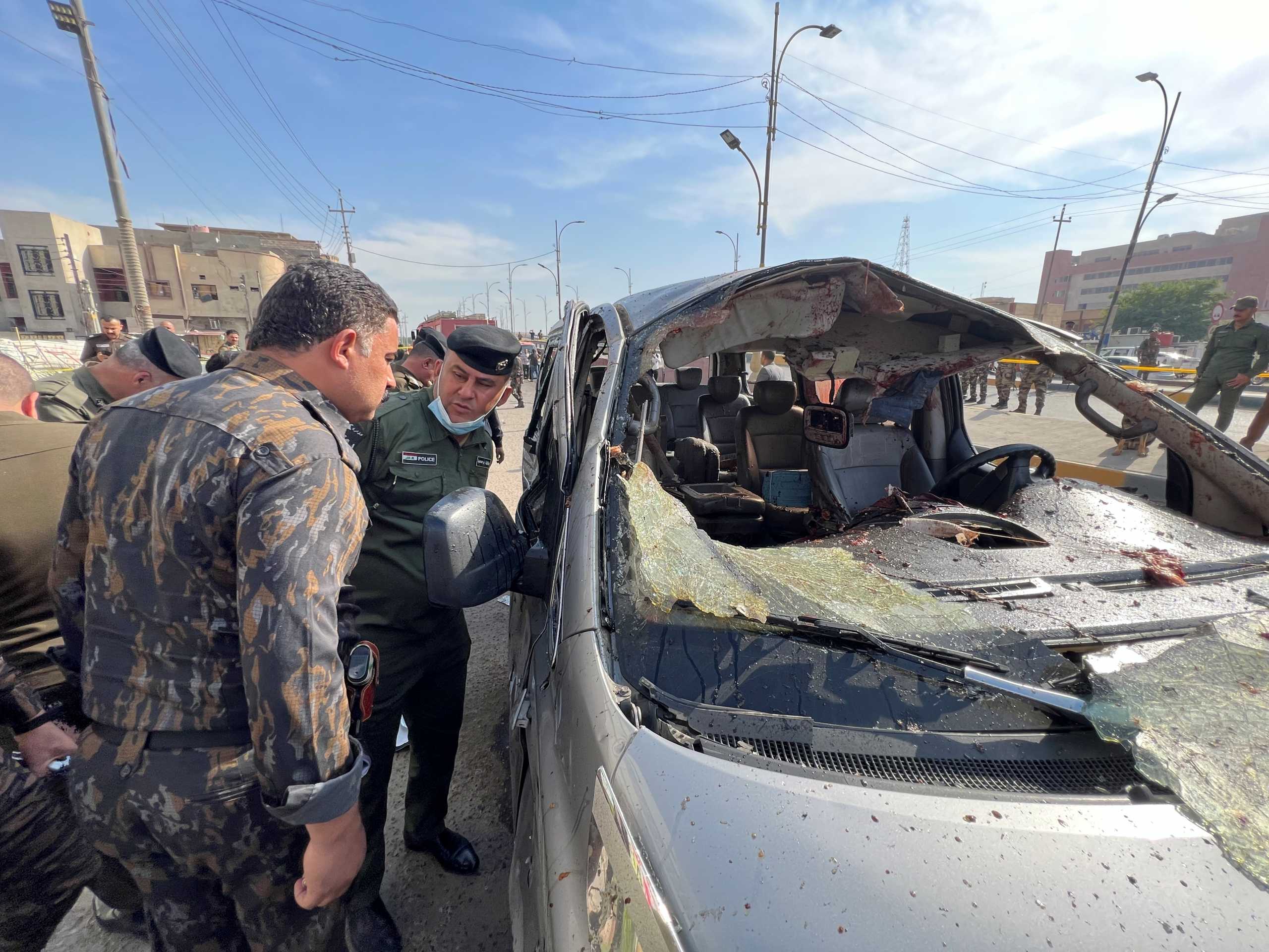 Iraqi security forces inspect the site of an explosion in Basra, Iraq December 7, 2021. REUTERS