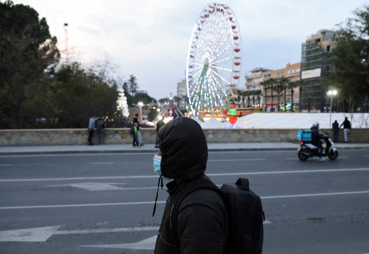 A man wearing a protective face mask walks on a road amid the coronavirus disease (COVID-19) outbreak in Nicosia, Cyprus December 29, 2021. REUTERS