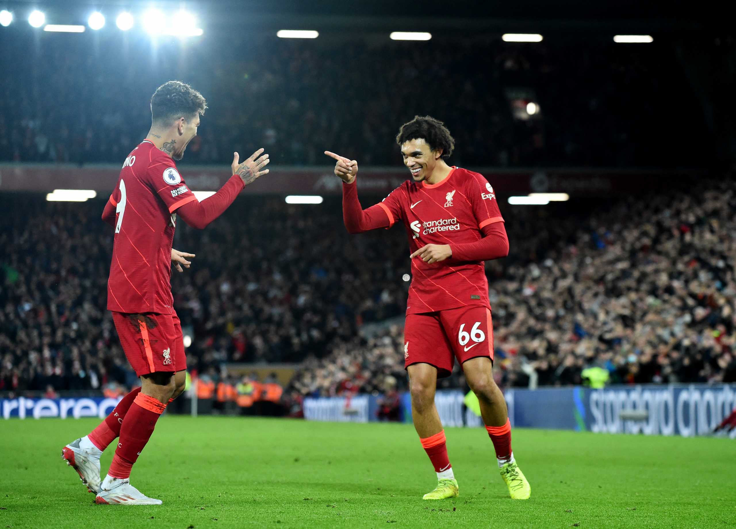 Soccer Football - Premier League - Liverpool v Newcastle United - Anfield, Liverpool, Britain - December 16, 2021 Liverpool's Trent Alexander-Arnold celebrates scoring their third goal with Roberto Firmino REUTERS
