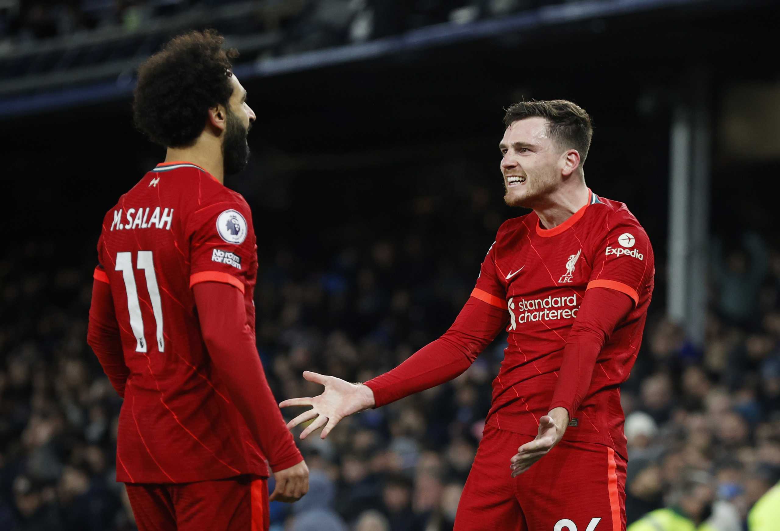 Soccer Football - Premier League - Everton v Liverpool - Goodison Park, Liverpool, Britain - December 1, 2021 Liverpool's Mohamed Salah celebrates scoring their third goal with Andrew Robertson REUTERS