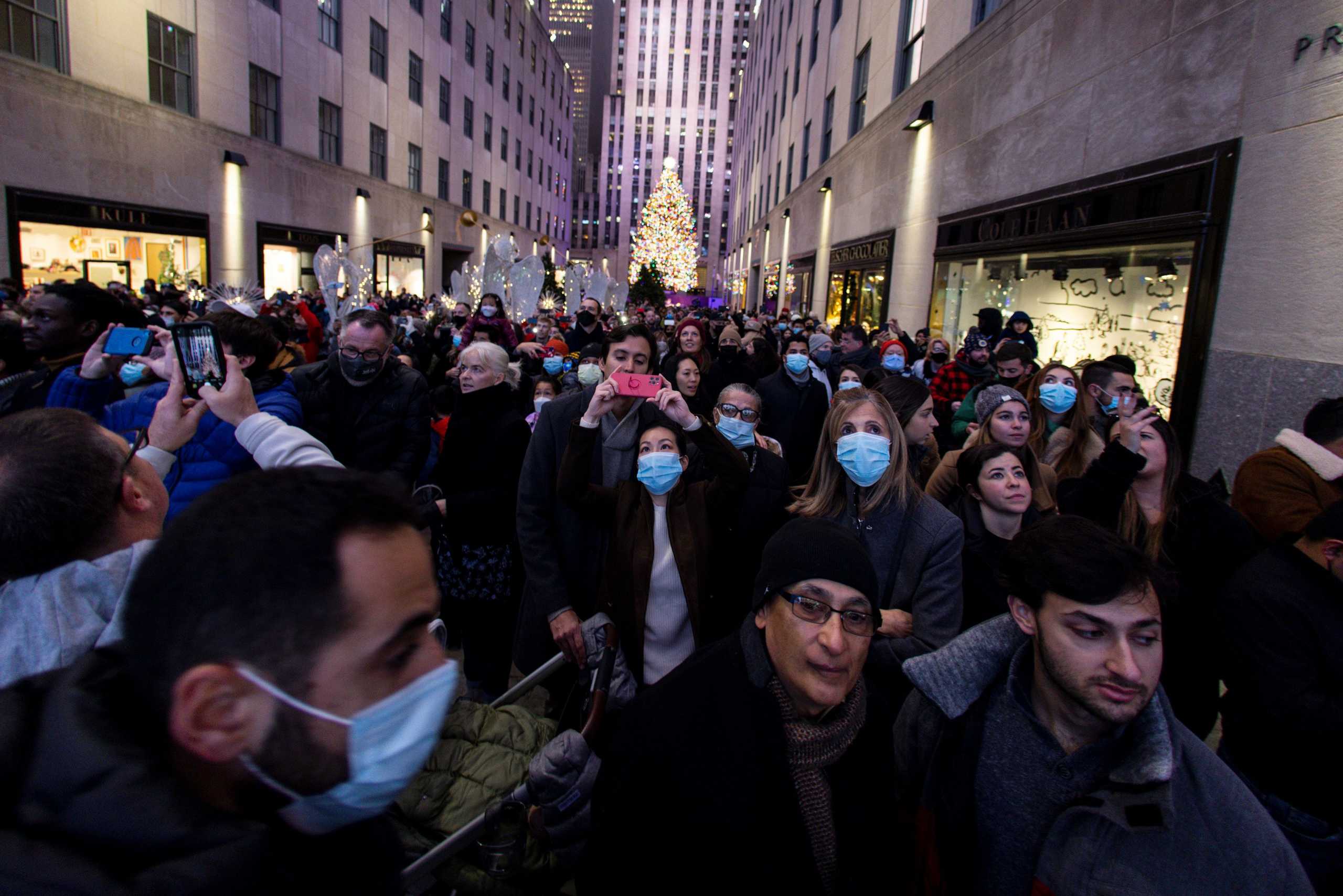 People watch the light display at Saks Fifth Avenue while the Christmas spirit arrives to New York City, New York, U.S., December 5, 2021. REUTERS
