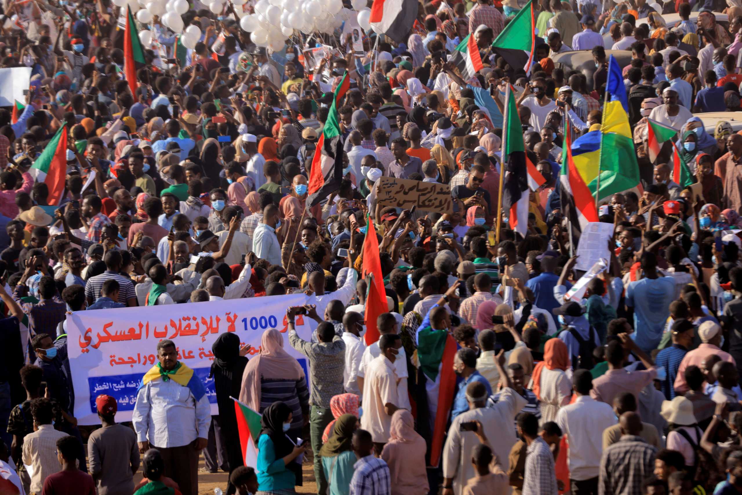 Protesters march during a rally from Khartoum North to Omdurman against military rule following last month's coup, in Khartoum, Sudan. December 13,2021. REUTERS