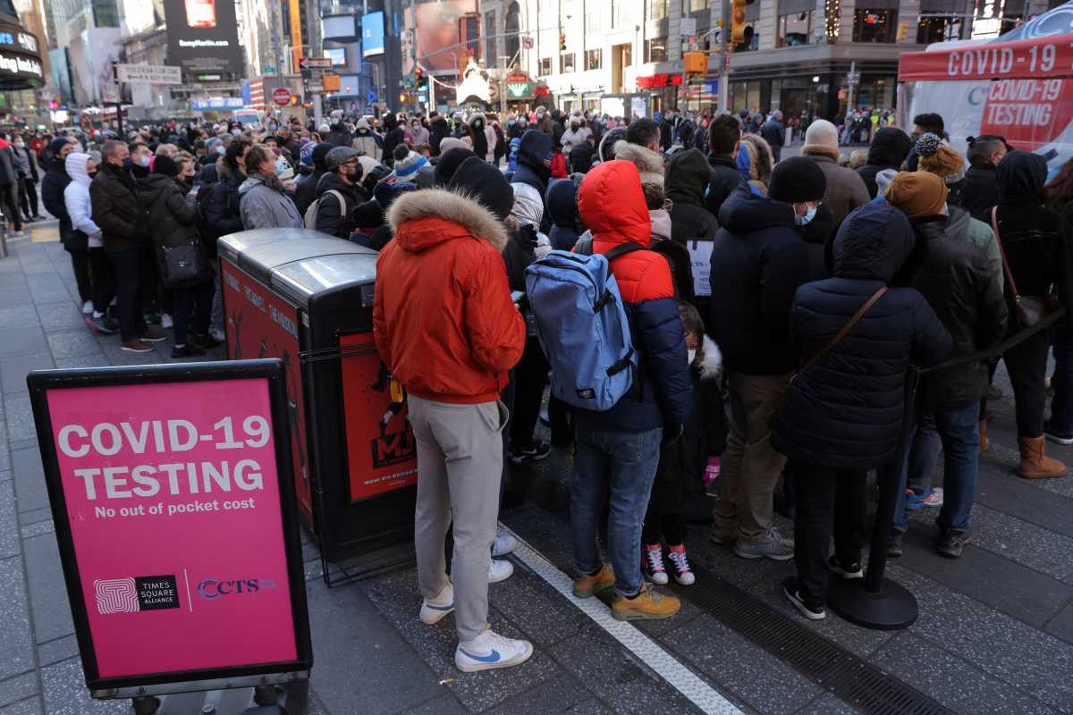 People queue for a COVID-19 test in Times Square as the Omicron coronavirus variant continues to spread in Manhattan, New York City, U.S., December 26, 2021. REUTERS