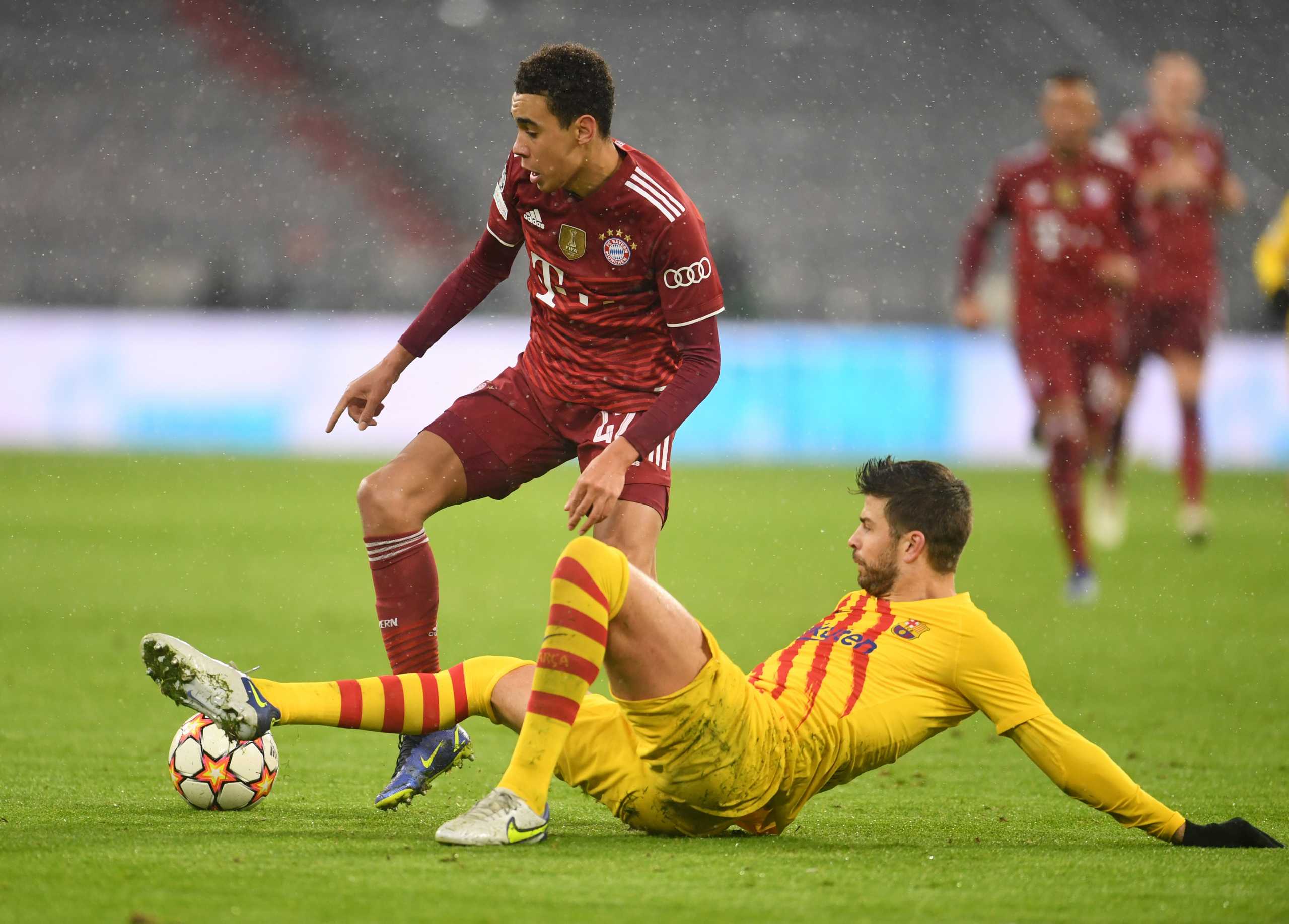 Soccer Football - Champions League - Group E - Bayern Munich v FC Barcelona - Allianz Arena, Munich, Germany - December 8, 2021 Bayern Munich's Jamal Musiala in action with FC Barcelona's Gerard Pique REUTERS