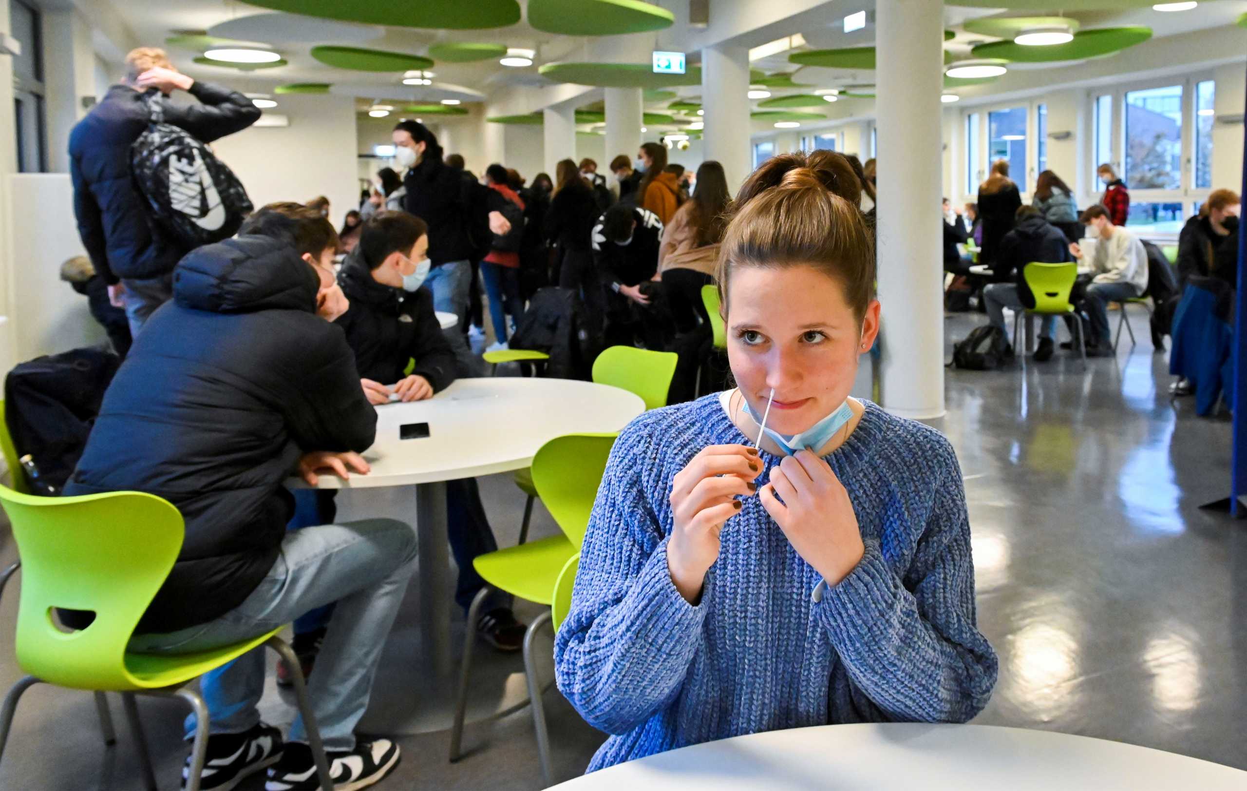 A student tests themselves for Coronavirus before starting lessons at a grammar school in Dresden, Germany, November 18, 2021. REUTERS