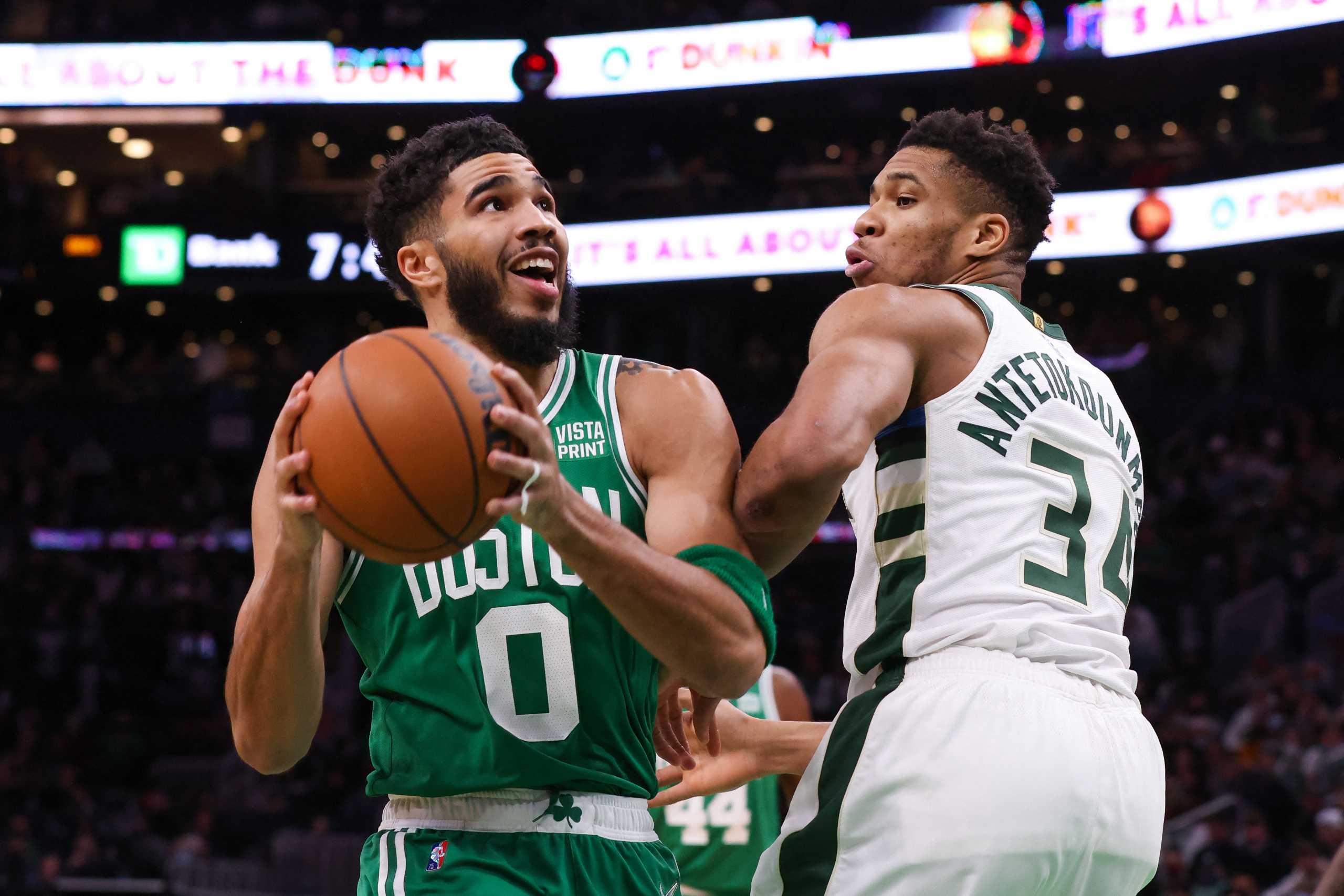 Dec 13, 2021; Boston, Massachusetts, USA; Boston Celtics forward Jayson Tatum (0) drives to the basket while defended by Milwaukee Bucks forward Giannis Antetokounmpo (34) during the first half at TD Garden. Mandatory Credit: Paul Rutherford-USA TODAY Sports