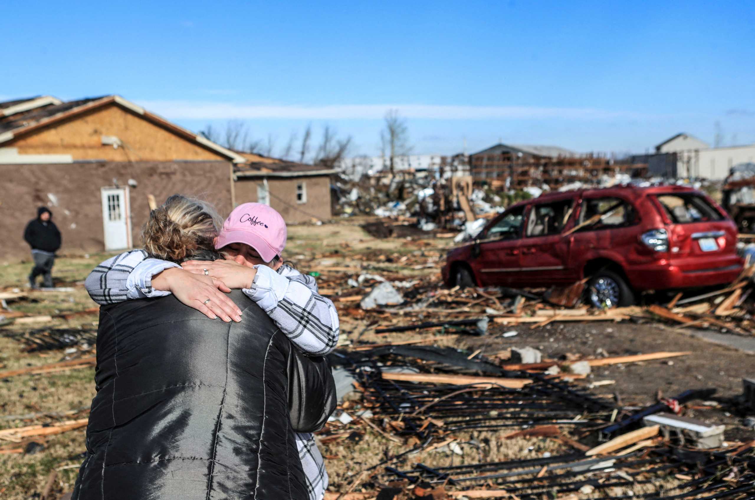 Irene Noltner consoles Jody O'Neill outside The Lighthouse, a women and children's shelter that was destroyed by a tornado along with much of the downtown of Mayfield, Kentucky, U.S. December 11, 2021.  Matt Stone
