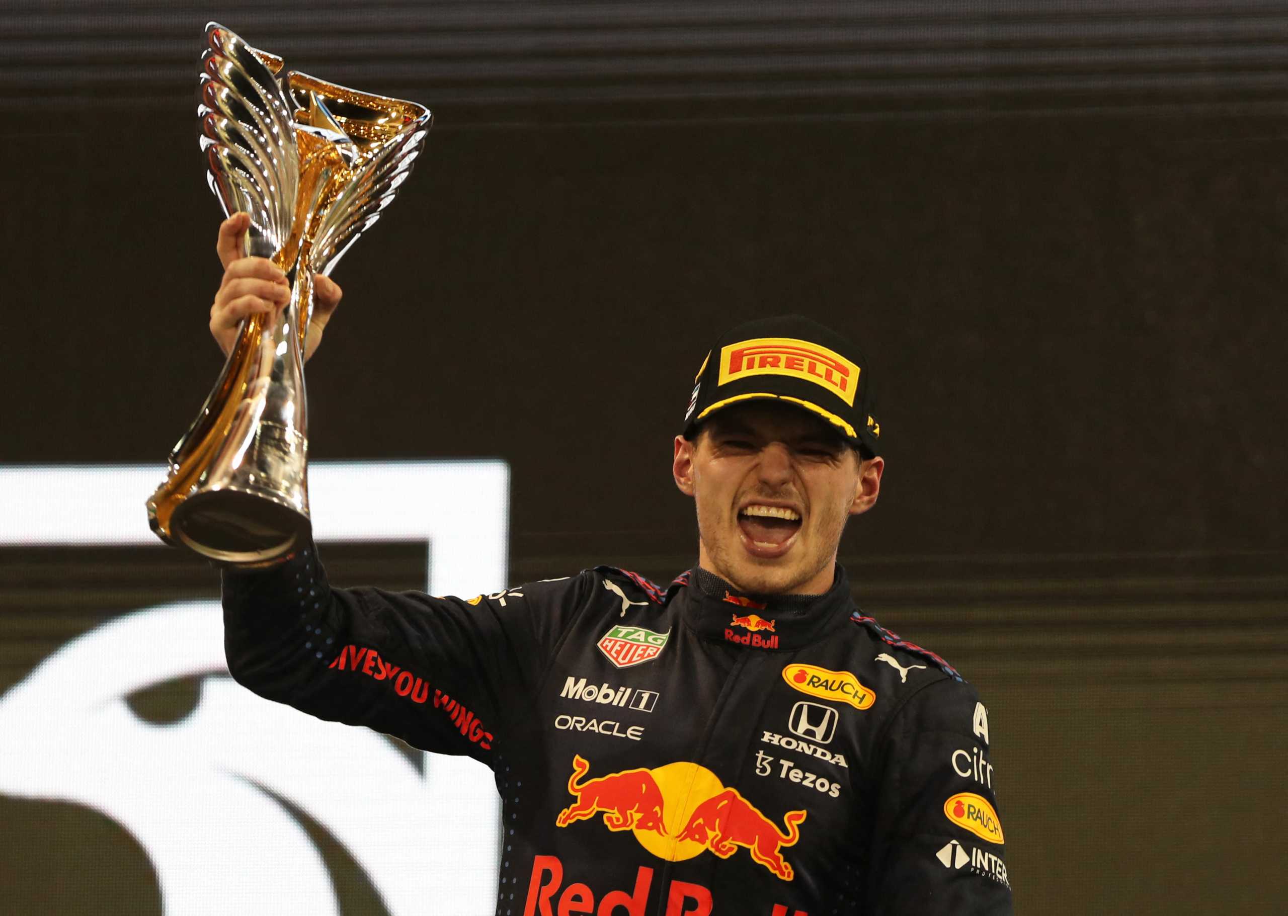 Formula One F1 - Abu Dhabi Grand Prix - Yas Marina Circuit, Abu Dhabi, United Arab Emirates - December 12, 2021 Red Bull's Max Verstappen celebrates winning the race and the world championship on the podium with the trophy Pool via REUTERS