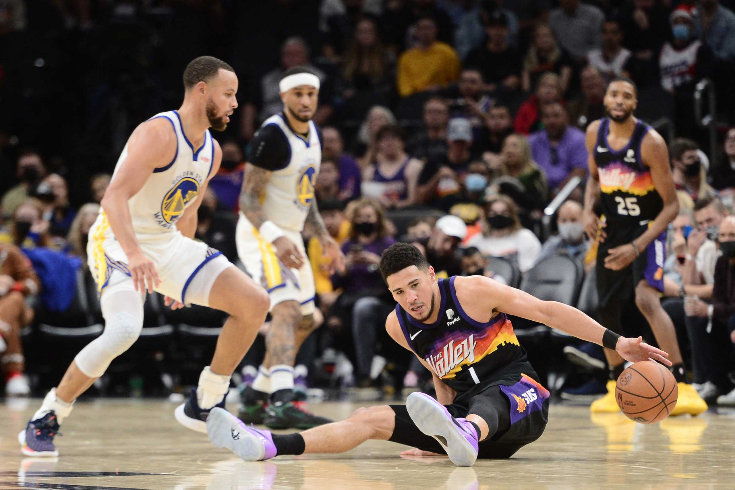 Dec 25, 2021; Phoenix, Arizona, USA; Phoenix Suns guard Devin Booker (1) is fouled by Golden State Warriors guard Stephen Curry (30) during the second half at Footprint Center. Mandatory Credit: Joe Camporeale-USA TODAY Sports
