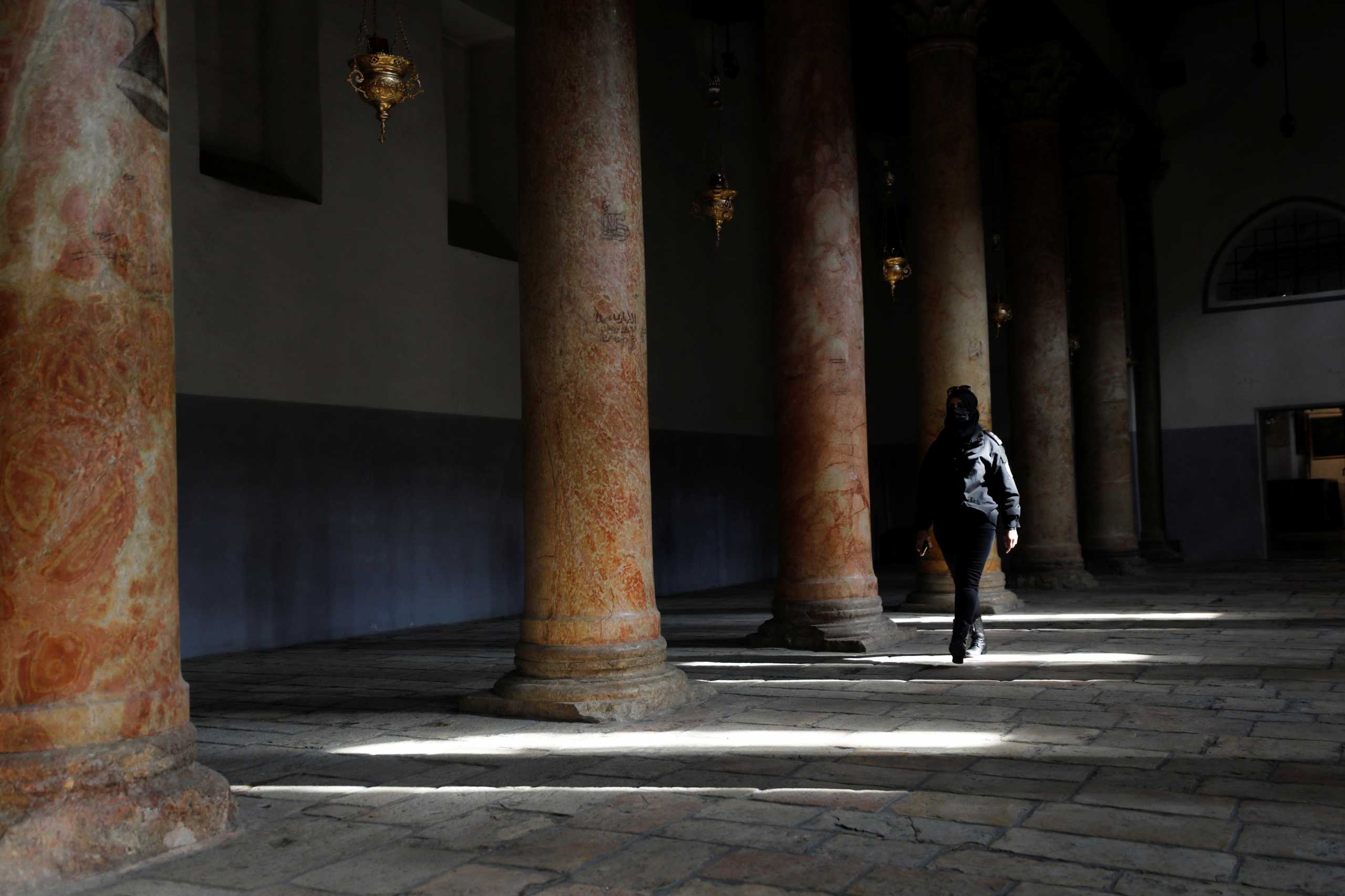 A Palestinian police woman walks in the Church of Nativity in Bethlehem in the Israeli-occupied West Bank November 18, 2021. Picture taken November 18, 2021. REUTERS