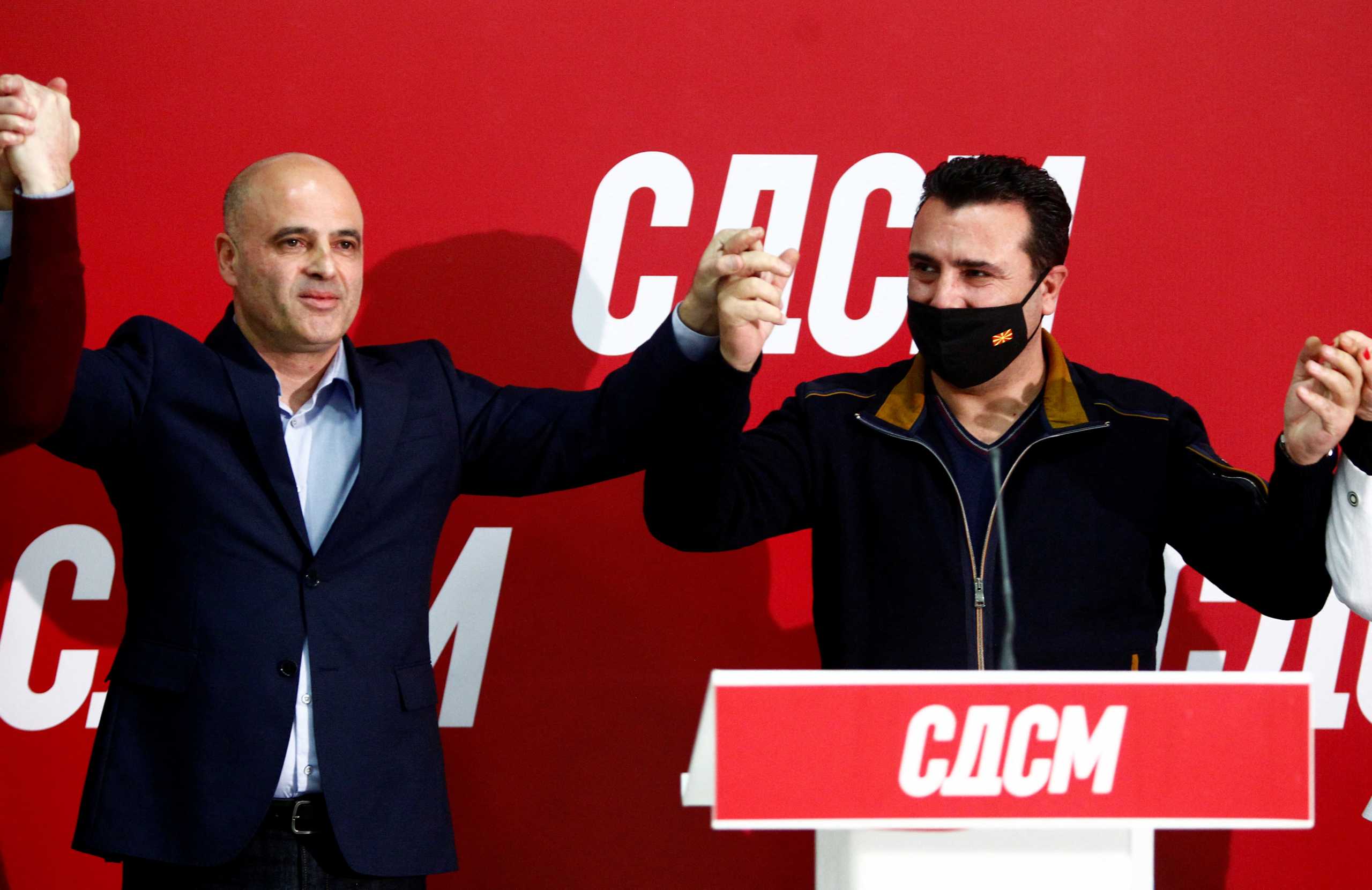 Newly elected leader of SDSM Dimitar Kovacevski celebrates his victory with his predecessor Prime Minister Zoran Zaev in Skopje, North Macedonia. December 12, 2021.REUTERS