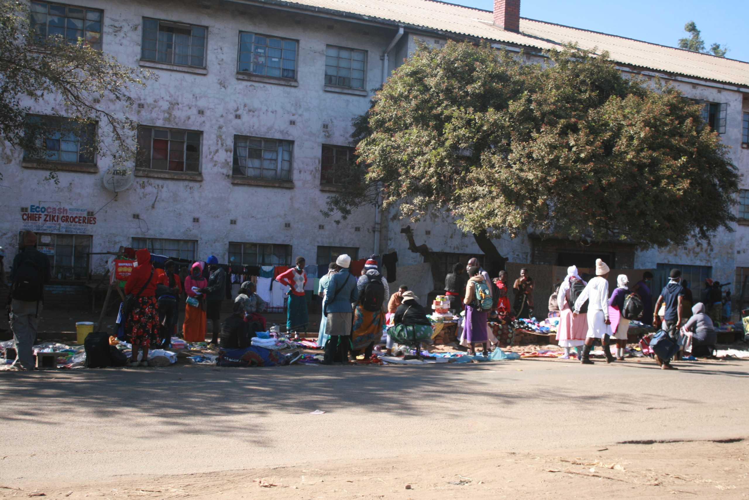 Informal traders sell wares on a street in a Harare suburb in Zimbabwe, May 23, 2020. Thomson Reuters Foundation