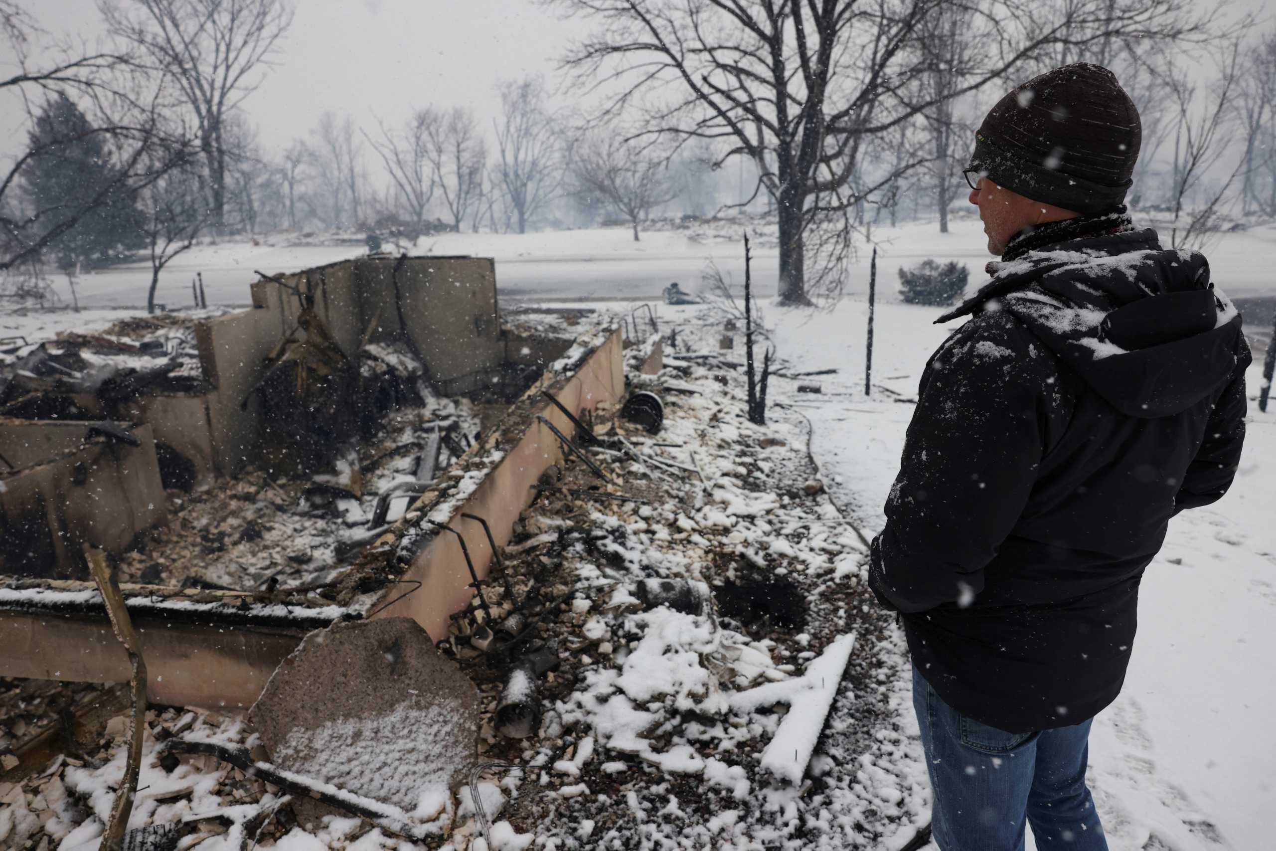 Chris Dreier looks at his house burned by wildfires, a day after evacuation orders, in Louisville, Colorado, U.S., December 31, 2021. REUTERS