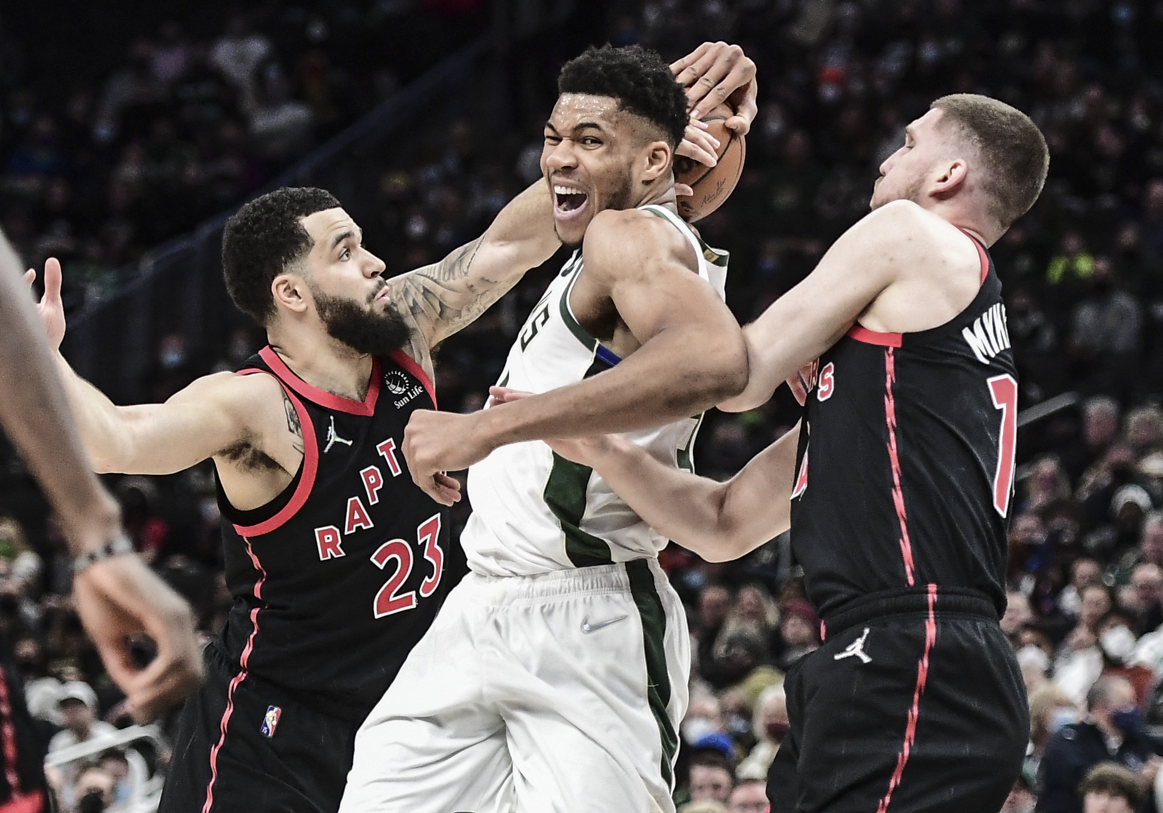 Jan 15, 2022; Milwaukee, Wisconsin, USA;  Toronto Raptors guard Fred VanVleet (23) and guard Svi Mykhailiuk (14) put pressure on Milwaukee Bucks forward Giannis Antetokounmpo (34) in the second quarter at Fiserv Forum. Mandatory Credit: Benny Sieu-USA TODAY Sports