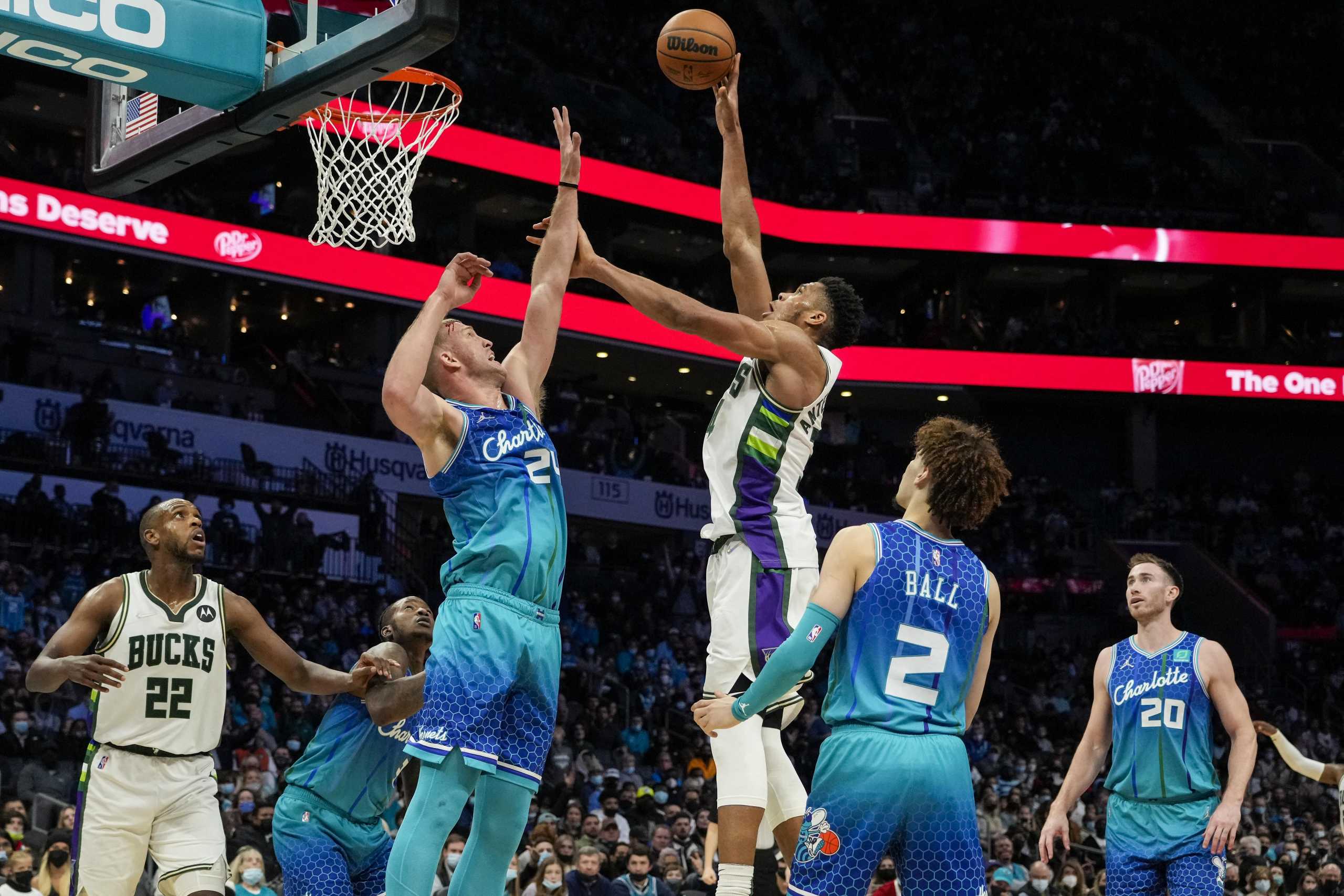 Jan 8, 2022; Charlotte, North Carolina, USA; Milwaukee Bucks forward Giannis Antetokounmpo (34) shoots the ball over Charlotte Hornets center Mason Plumlee (24) during the second half at the Spectrum Center. Mandatory Credit: Jim Dedmon-USA TODAY Sports