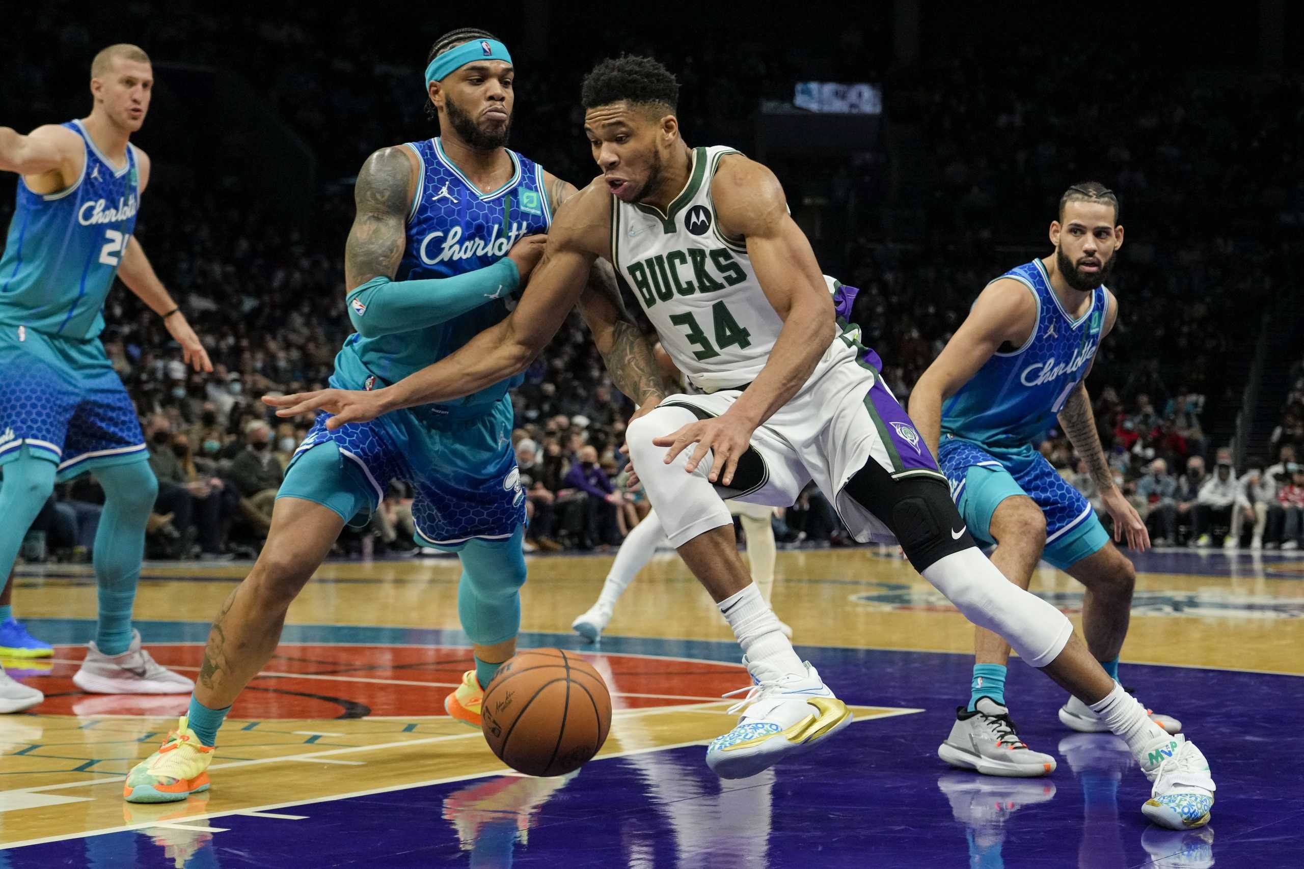 Jan 8, 2022; Charlotte, North Carolina, USA; Milwaukee Bucks forward Giannis Antetokounmpo (34) drives to the basket against Charlotte Hornets forward Miles Bridges (0) during the second half at the Spectrum Center. Mandatory Credit: Jim Dedmon-USA TODAY Sports