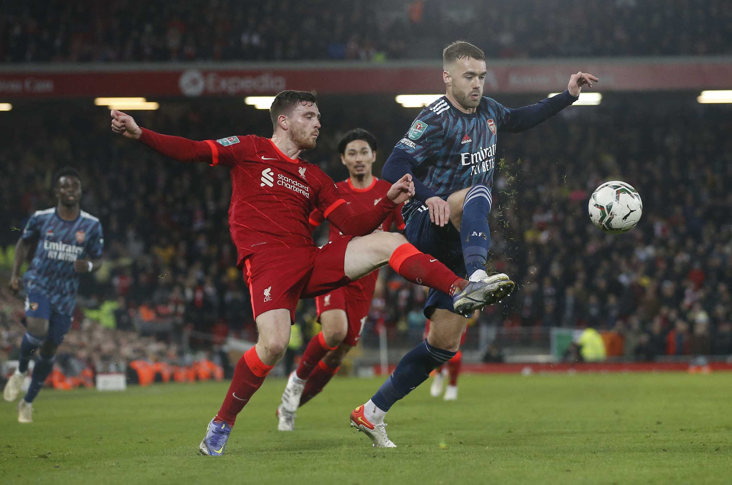 Soccer Football - Carabao Cup - Semi-Final - First Leg - Liverpool v Arsenal - Anfield, Liverpool, Britain - January 13, 2022  Liverpool's Andrew Robertson in action with Arsenal's Calum Chambers REUTERS