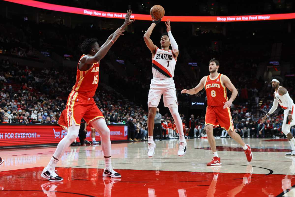 Jan 3, 2022; Portland, Oregon, USA; Portland Trail Blazers guard Anfernee Simons (1) shoots over Atlanta Hawks center Clint Capela (15) in the first half at Moda Center. Mandatory Credit: Jaime Valdez-USA TODAY Sports
