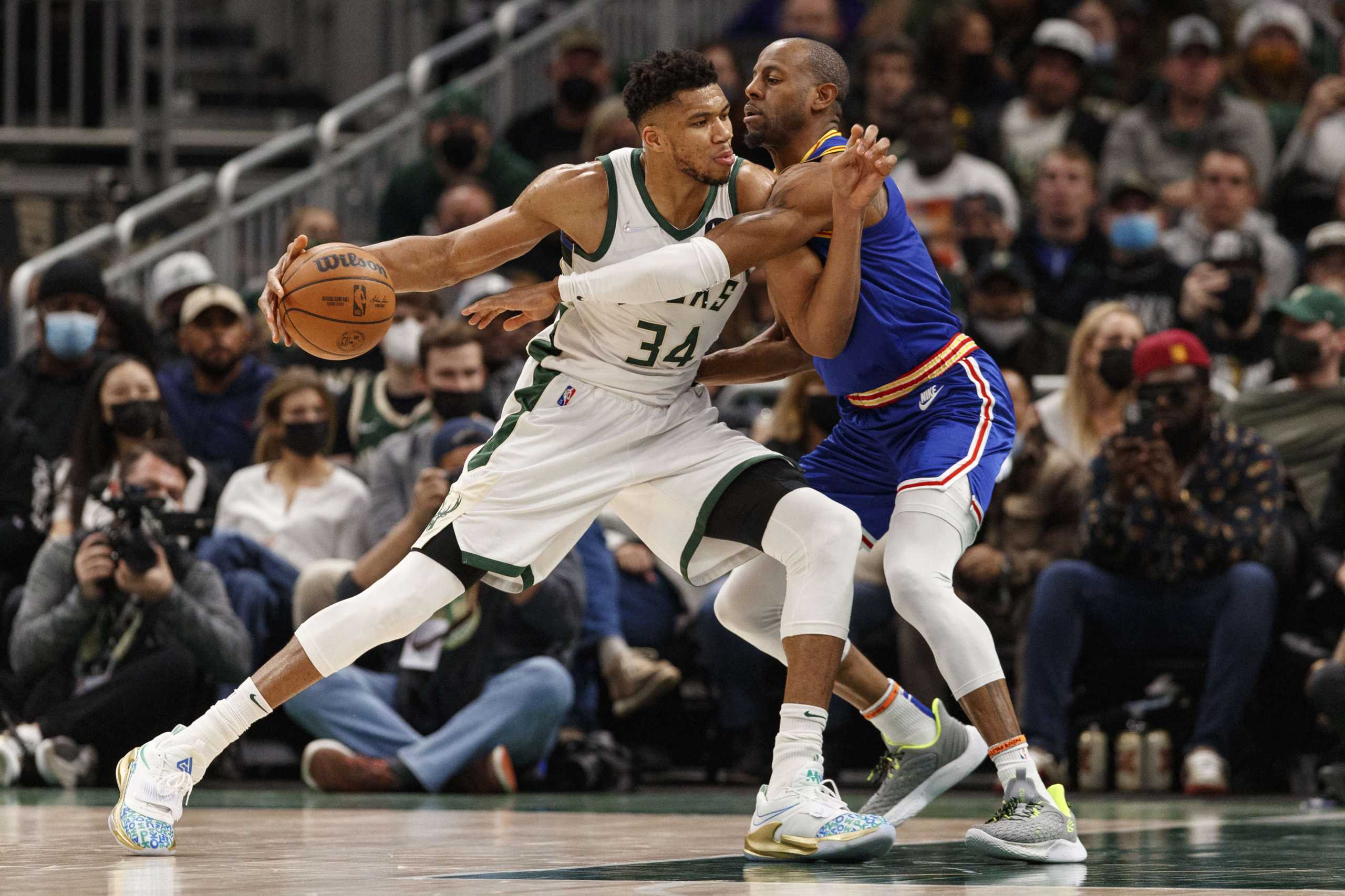 Jan 13, 2022; Milwaukee, Wisconsin, USA;  Golden State Warriors forward Andre Iguodala (9) defends Milwaukee Bucks forward Giannis Antetokounmpo (34) during the second quarter at Fiserv Forum. Mandatory Credit: Jeff Hanisch-USA TODAY Sports